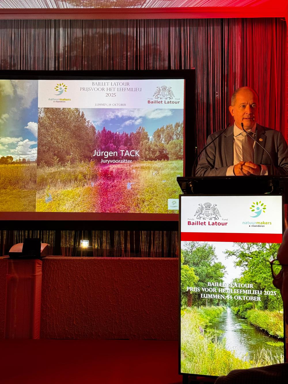Speaker at the lectern beside a slide naming jury chair Jurgen Tack, Baillet Latour Environment Prize 2025