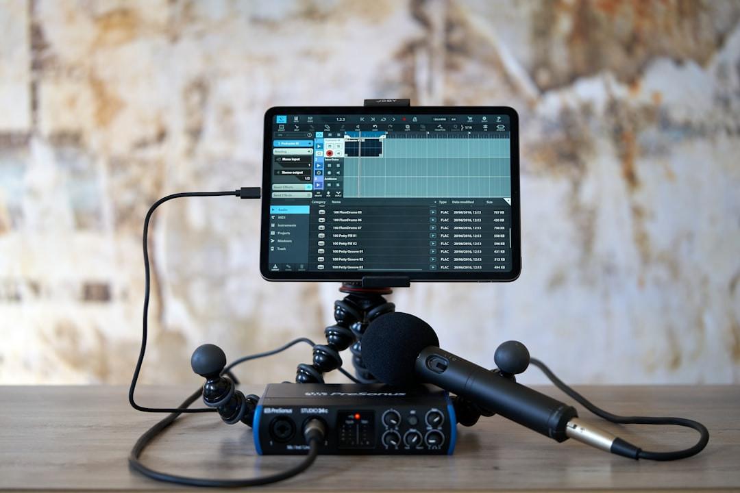 Tablet running recording software on a flexible tripod, with a PreSonus audio interface and microphone