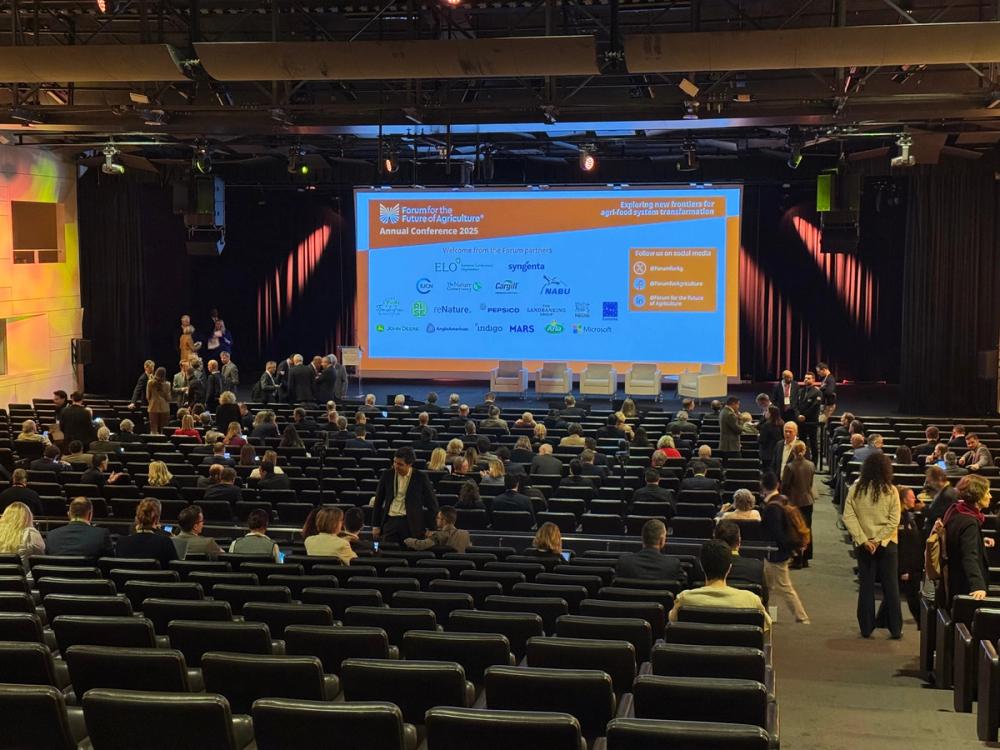 Conference hall filling up for the Forum for the Future of Agriculture 2025, partner logos on the main screen