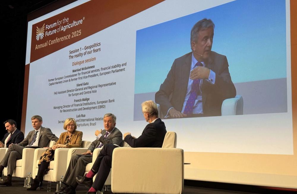 Forum for the Future of Agriculture 2025 geopolitics panel on stage, one speaker shown large on the screen