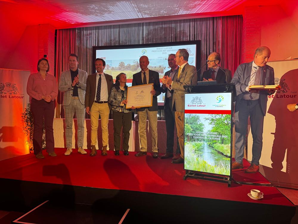 Group on stage holding a framed certificate at the Baillet Latour Environment Prize 2025 award ceremony