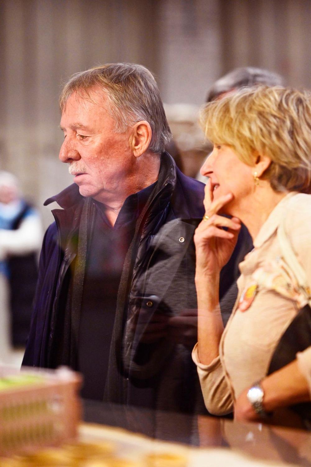 Older man and woman looking thoughtfully at a display during a Sustainable Stories event