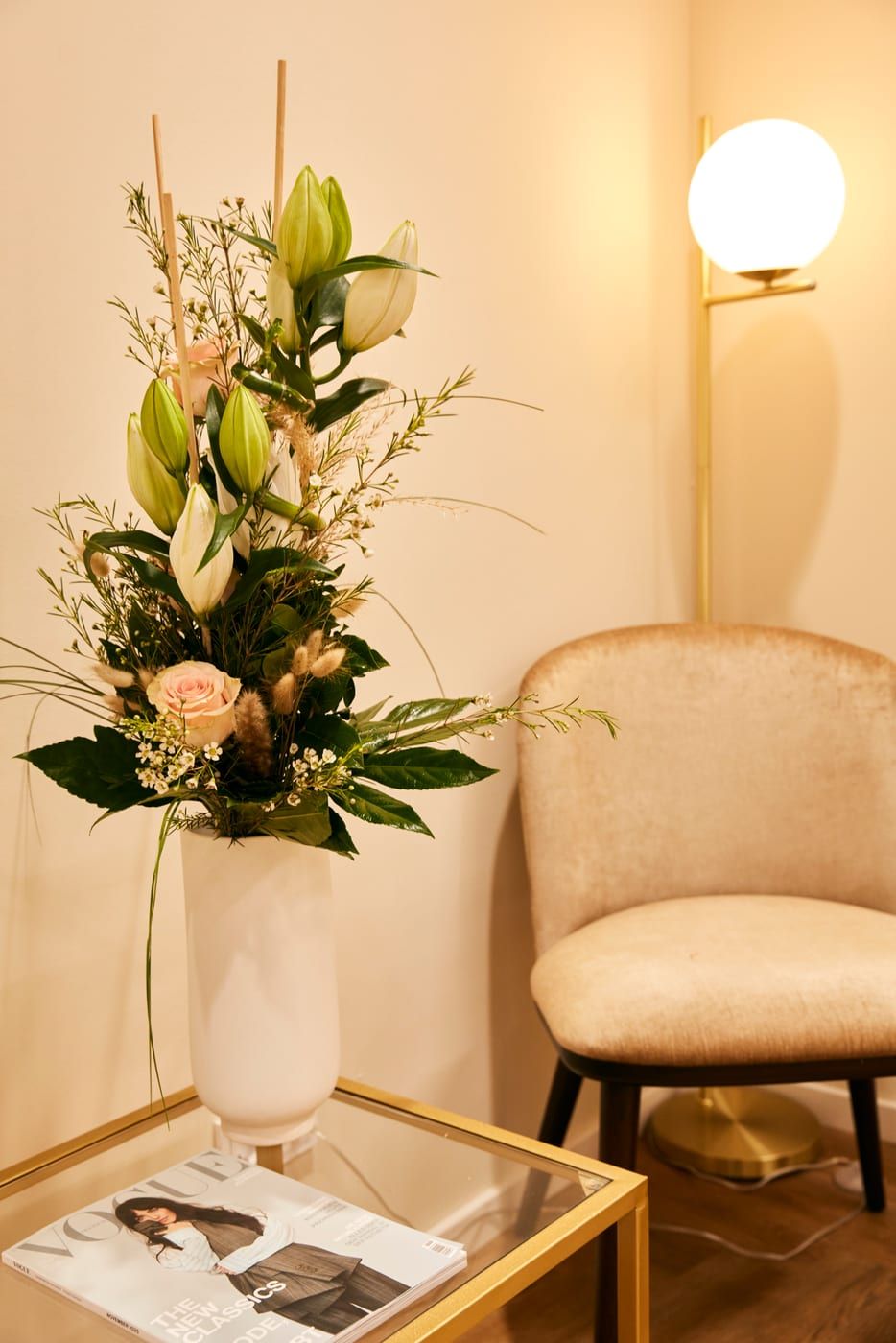 Ruhiger Wartebereich im Menopause Zentrum mit Blumengesteck und Sessel – eine angenehme, diskrete Atmosphäre für die persönliche Beratung.