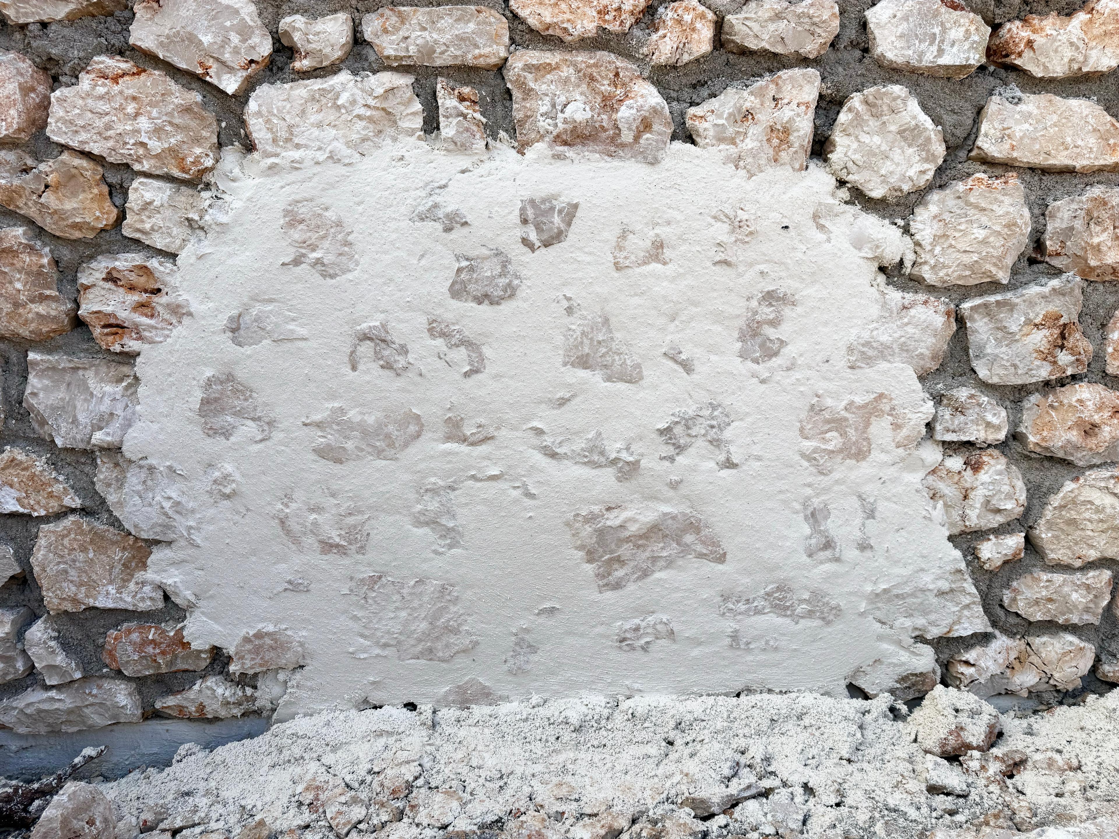 Sample shelter-coated stone wall finish