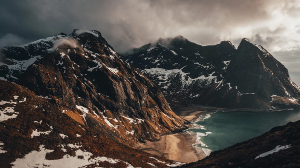Mountains in cloudly weather with a beach.