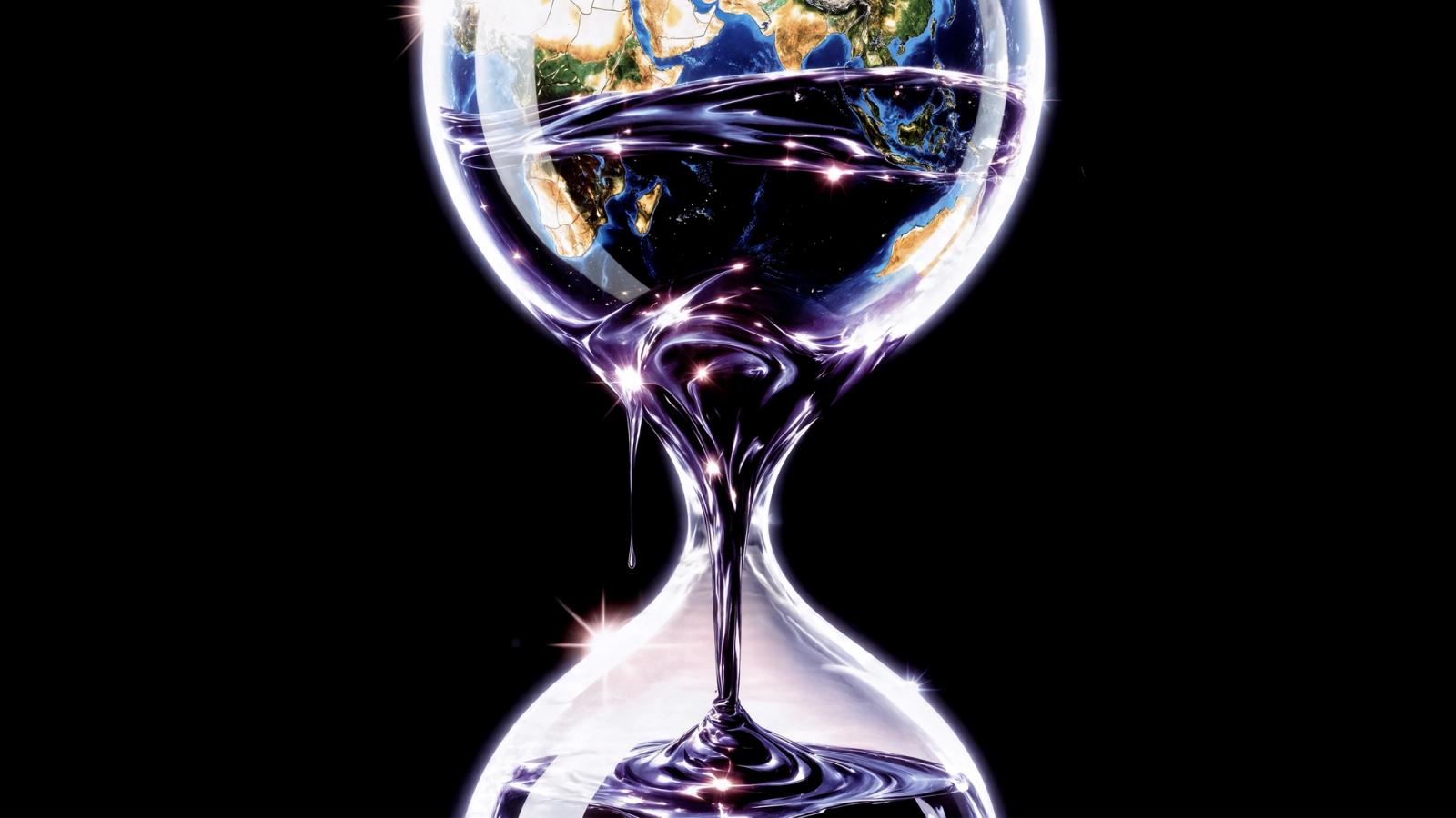 An hourglass with the Earth in its upper bulb, from which dark, oil-like liquid flows into the lower bulb.