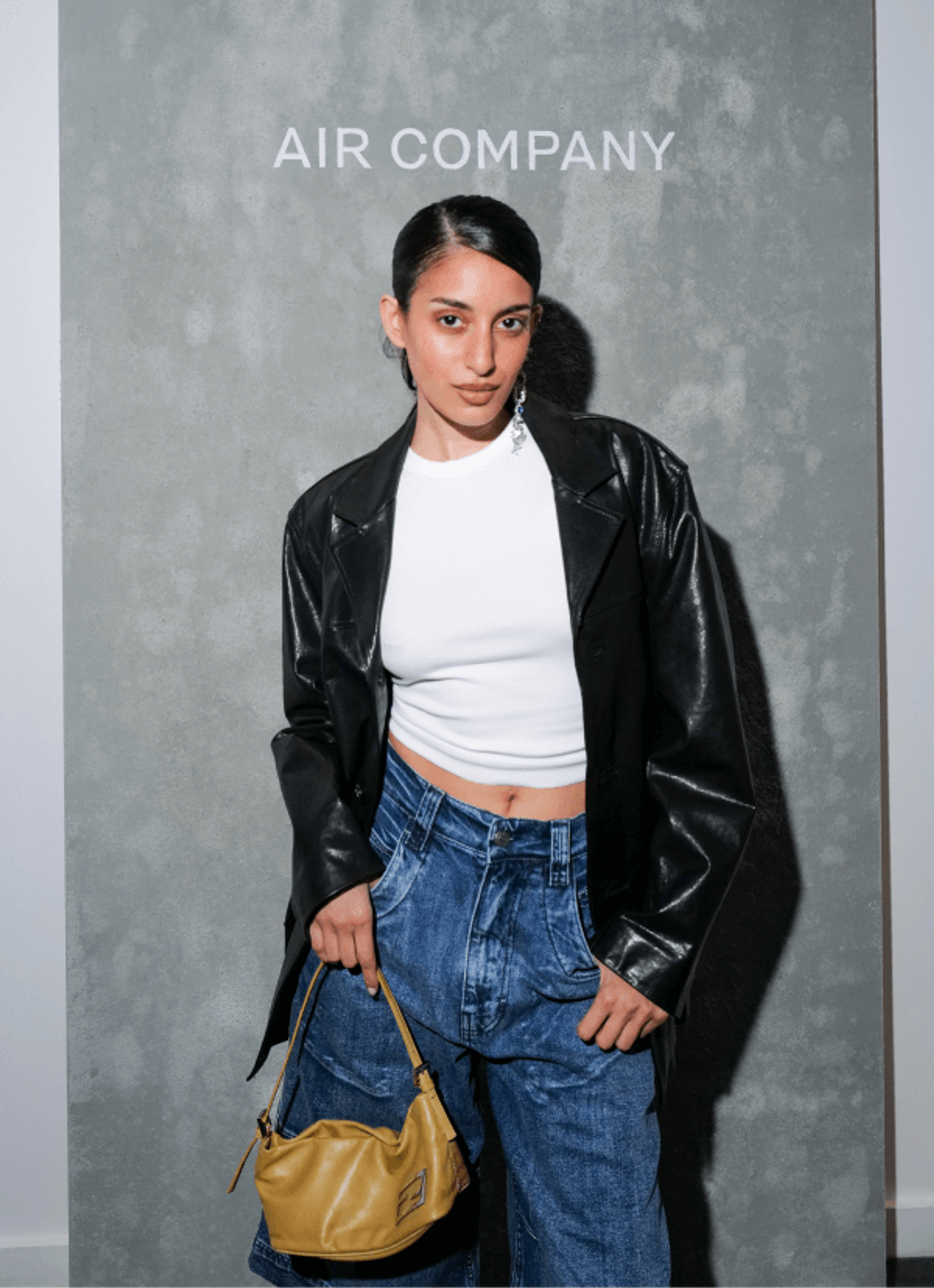 Anaa Saber in a leather jacket posing for an image at AIRCO/AIR COMPANY Fragrance dinner