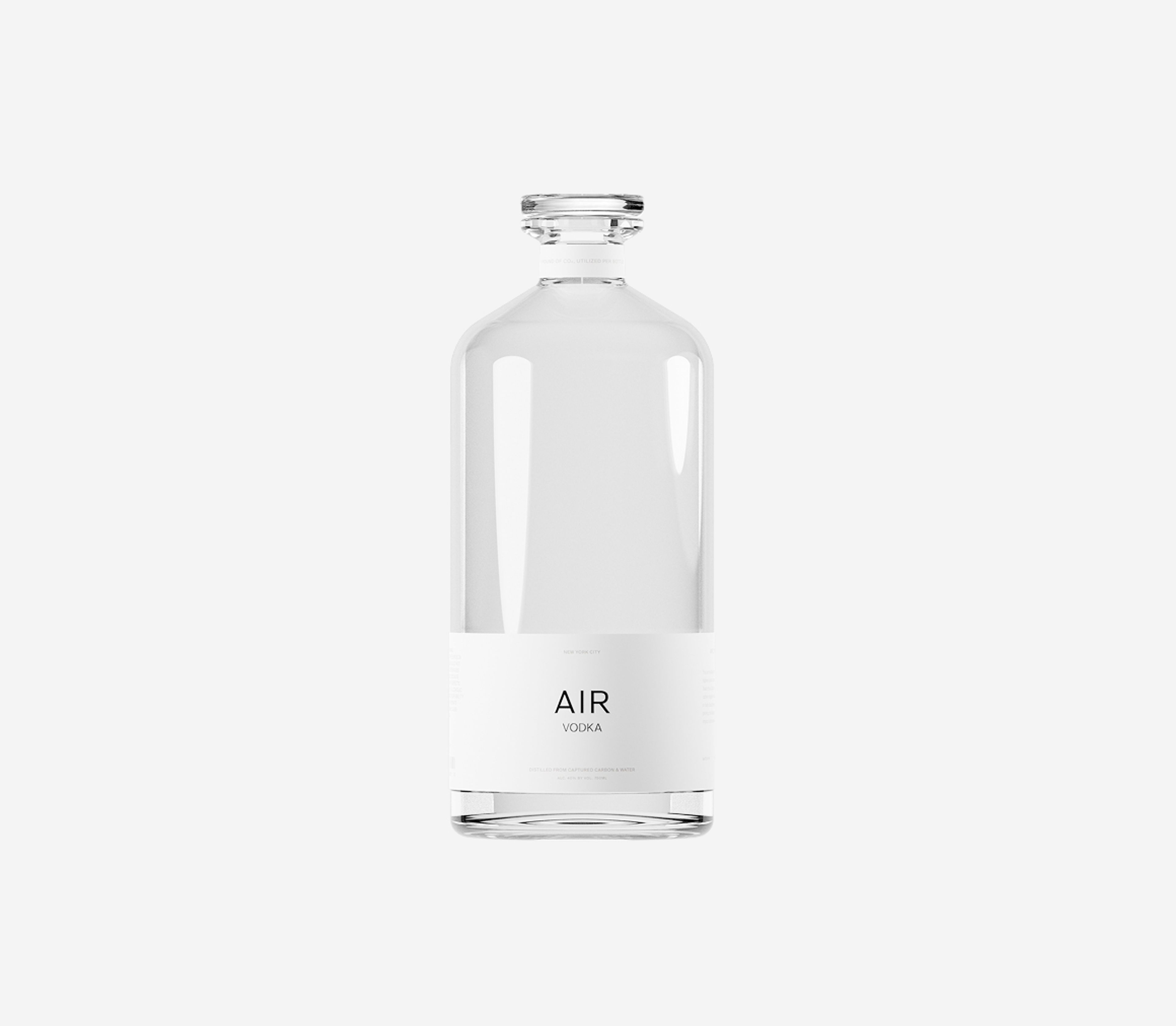 A clear glass bottle of Air Vodka with a minimalist white label on a white background.