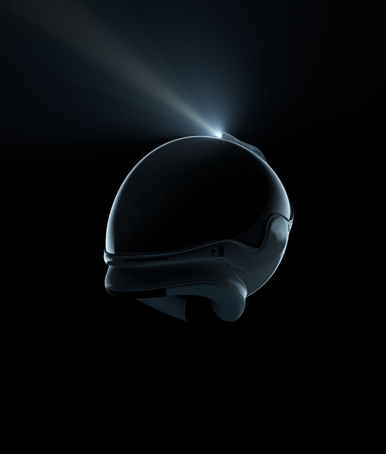 black silhouette of a space helmet with a white light beaming off the top 