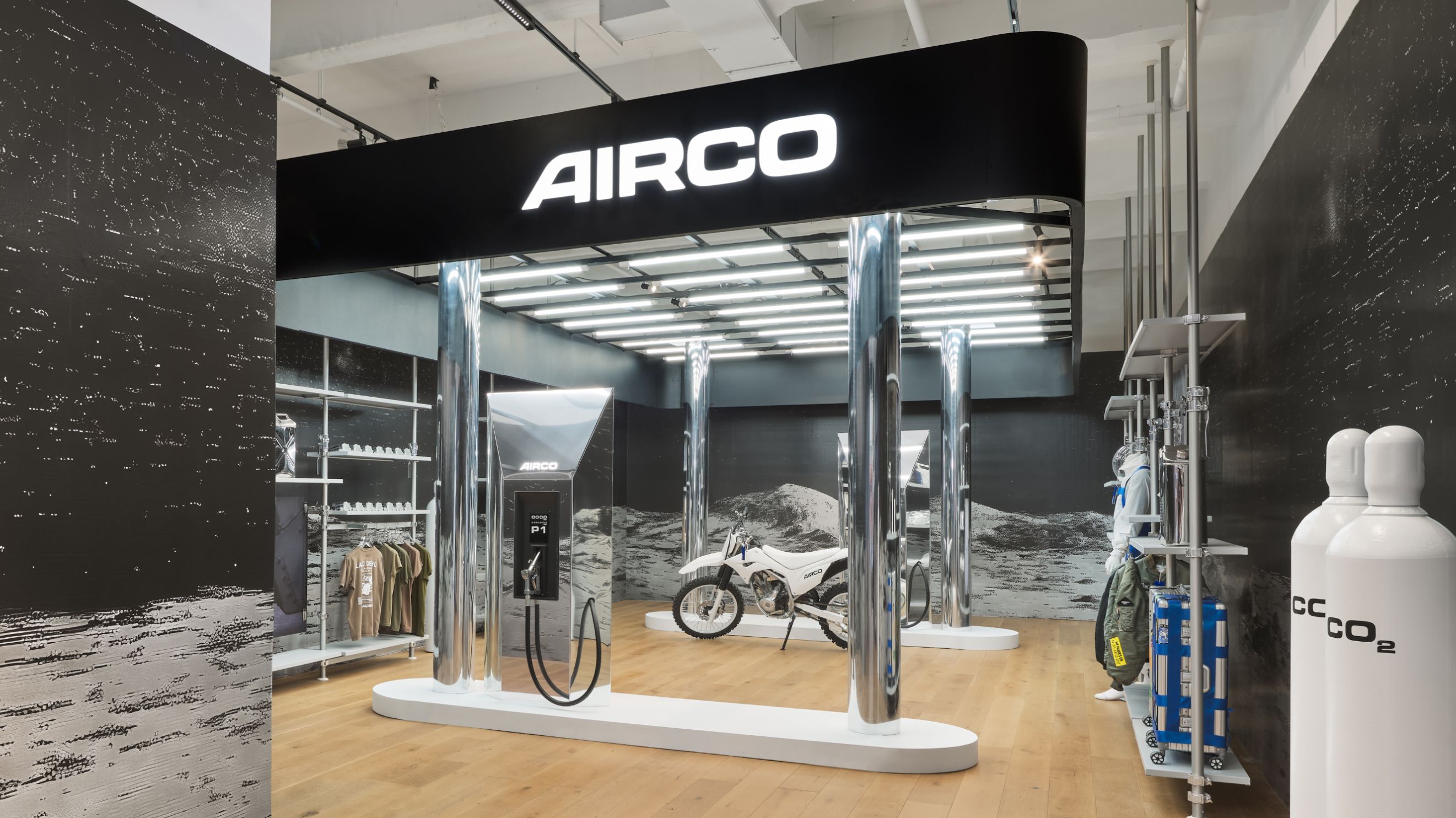 inside a store that is styled to look like a gas station with a motorbike and the logo AIRCO above it