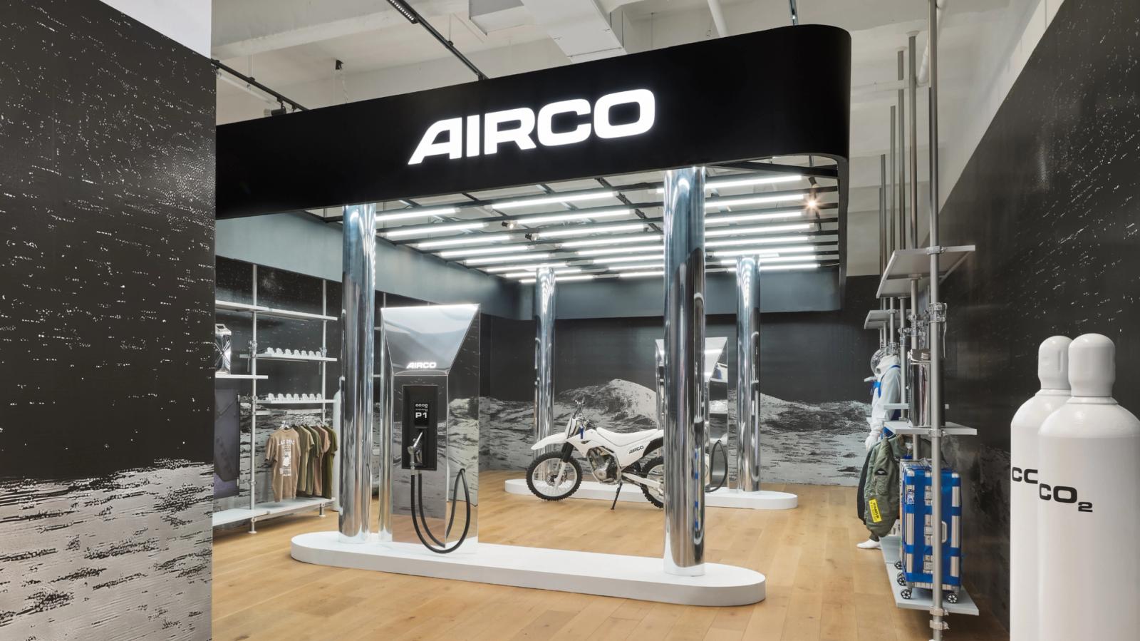 inside a store that is styled to look like a gas station with a motorbike and the logo AIRCO above it