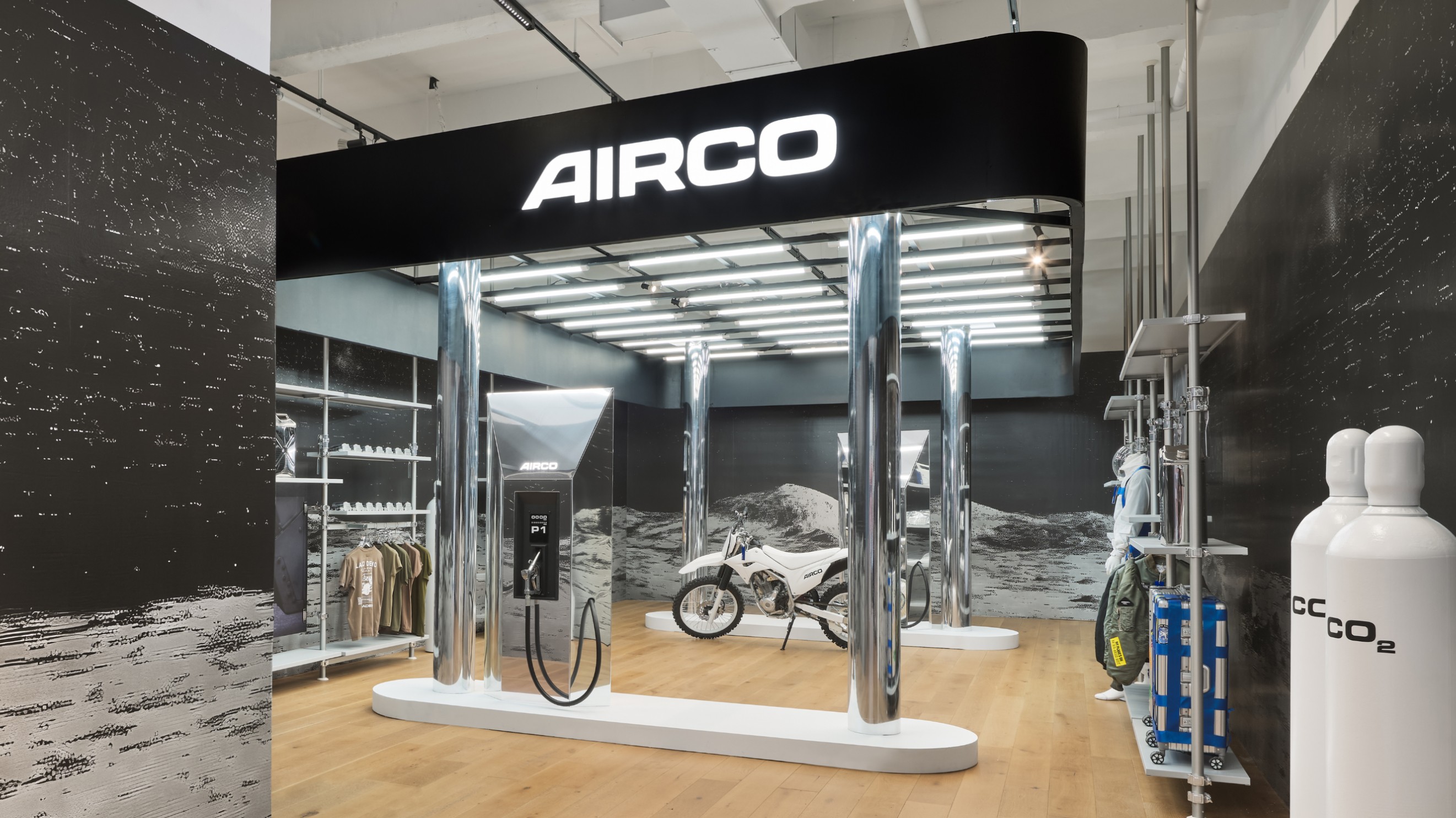 inside a store that is styled to look like a gas station with a motorbike and the logo AIRCO above it