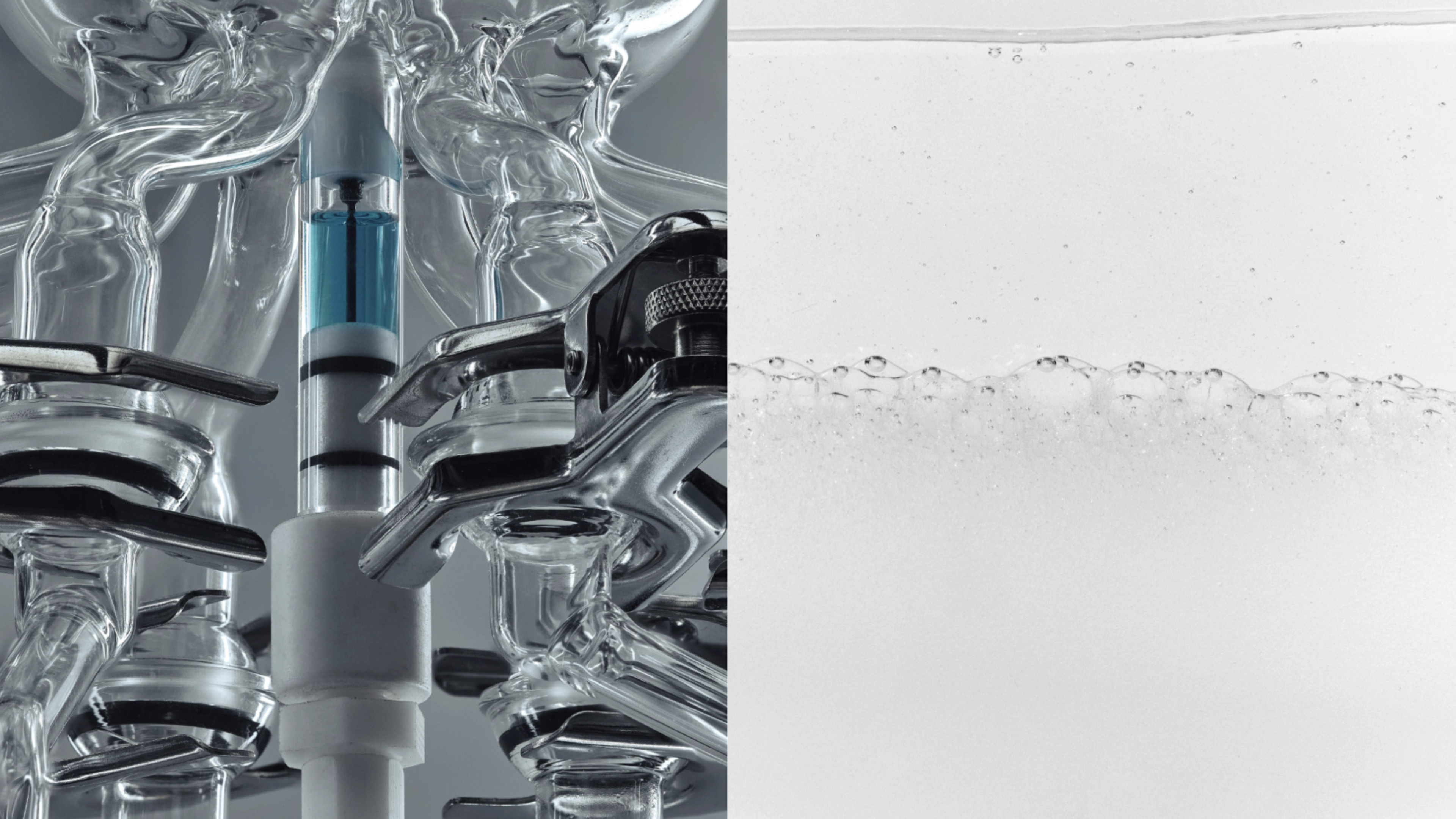 Laboratory glassware with a blue device on the left, and a clear liquid with bubbles on the right.