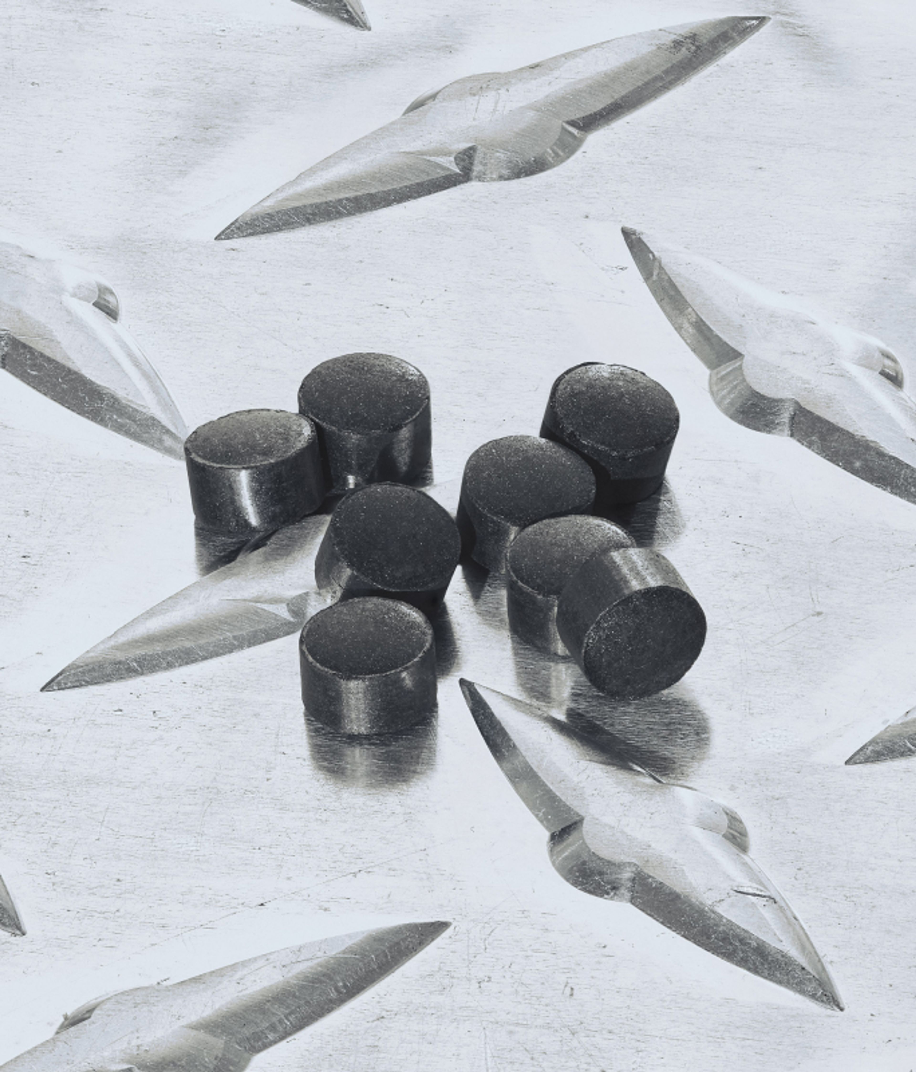 Eight catalyst pellets sitting on top of a metal table