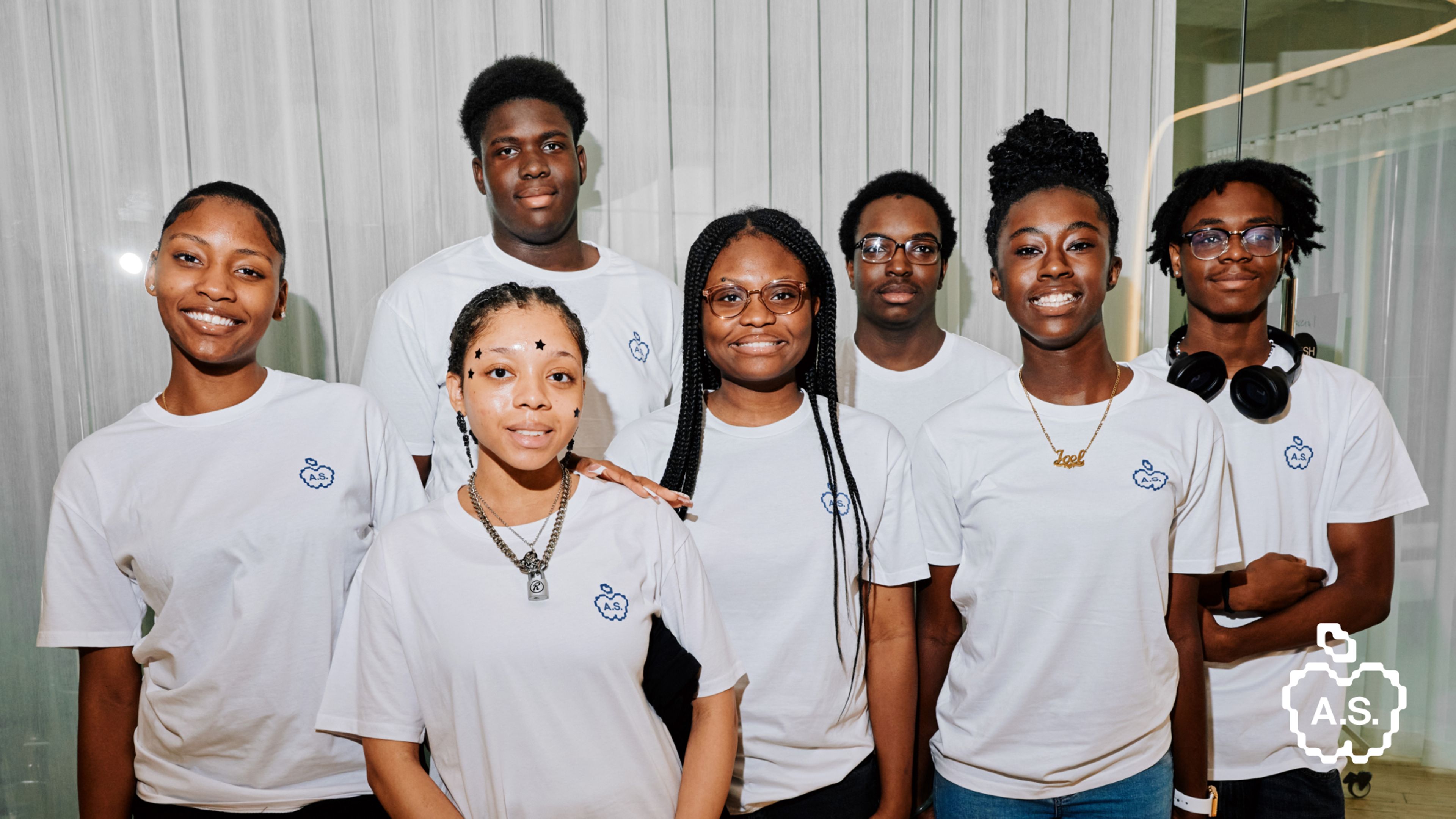 AIRCO's AIR Scholars Cohort 2 group smiling and wearing white t-shirts with a pixelated blue apple logo.