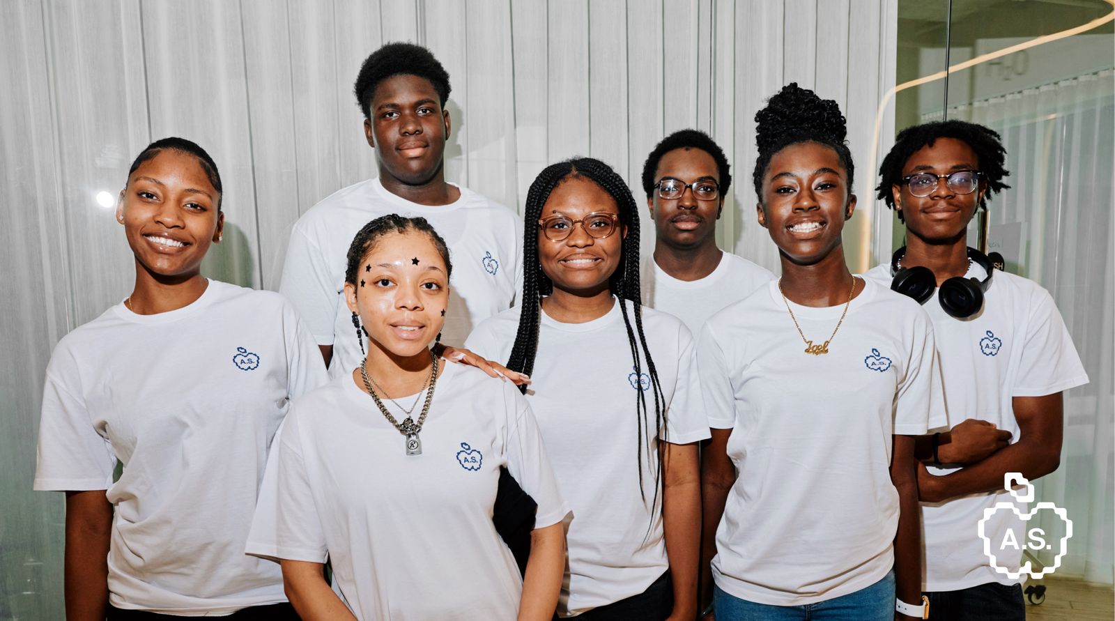 AIRCO's AIR Scholars Cohort 2 group smiling and wearing white t-shirts with a pixelated blue apple logo.