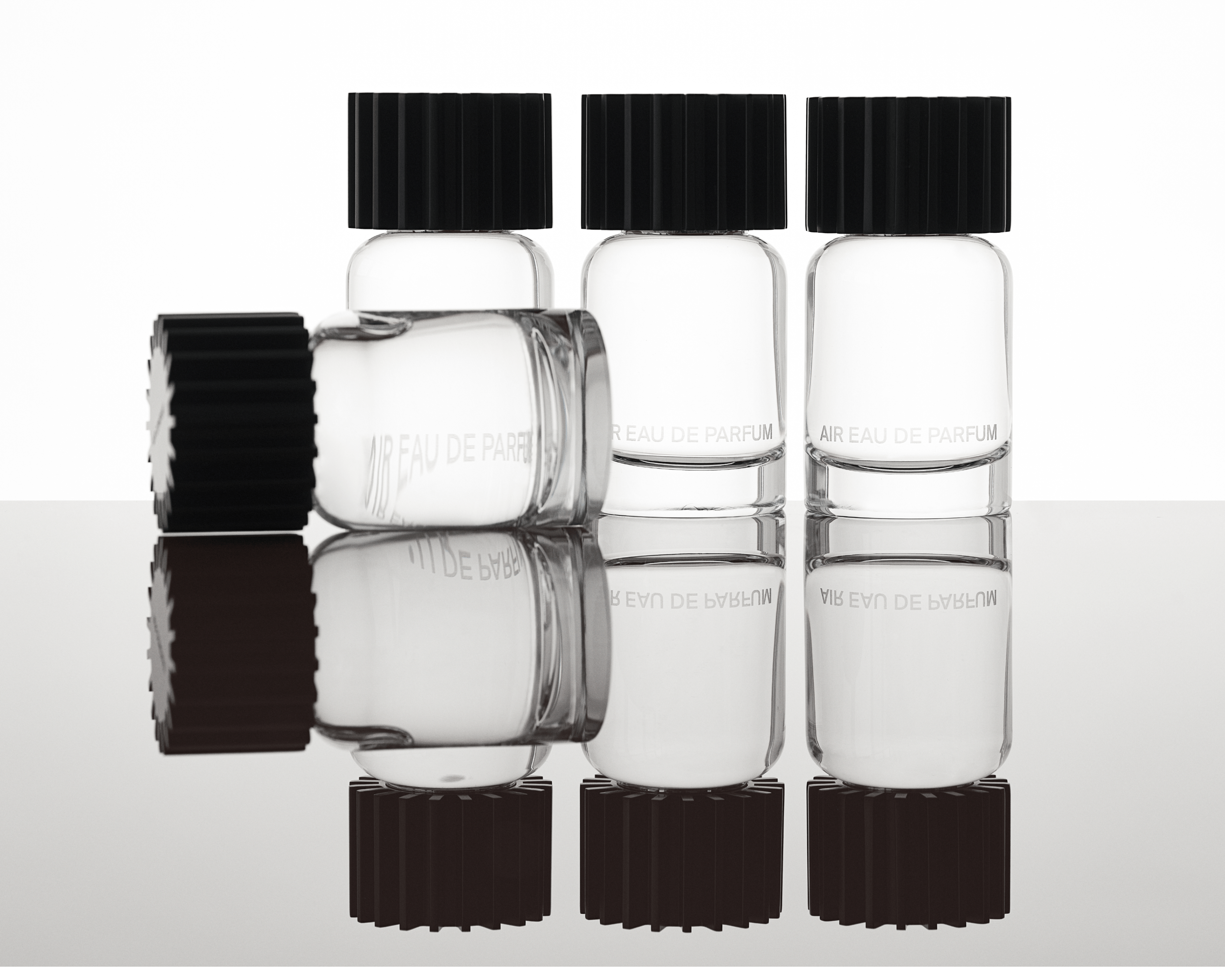 AIRCO (formerly AIR COMPANY)'s fragrance bottles in a row and one laying down in front. 