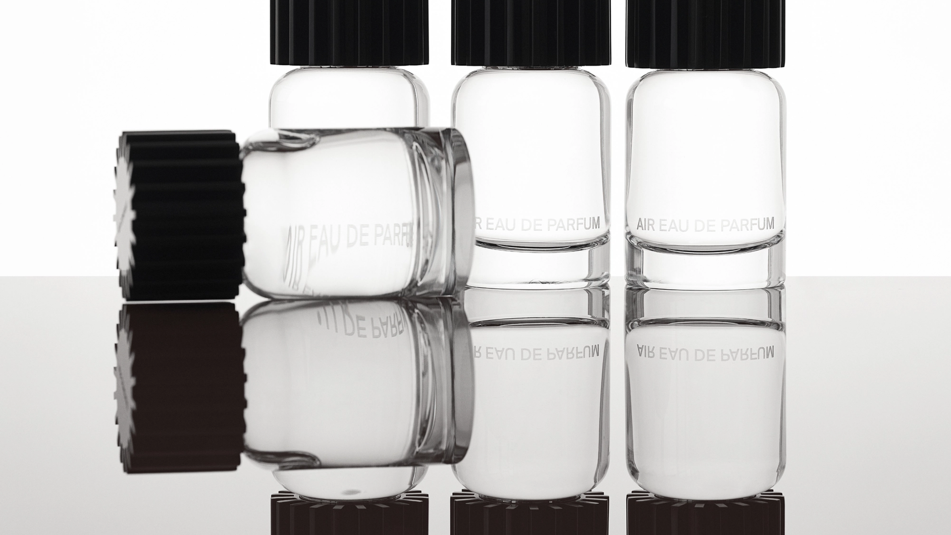 AIRCO (formerly AIR COMPANY)'s fragrance bottles in a row and one laying down in front.