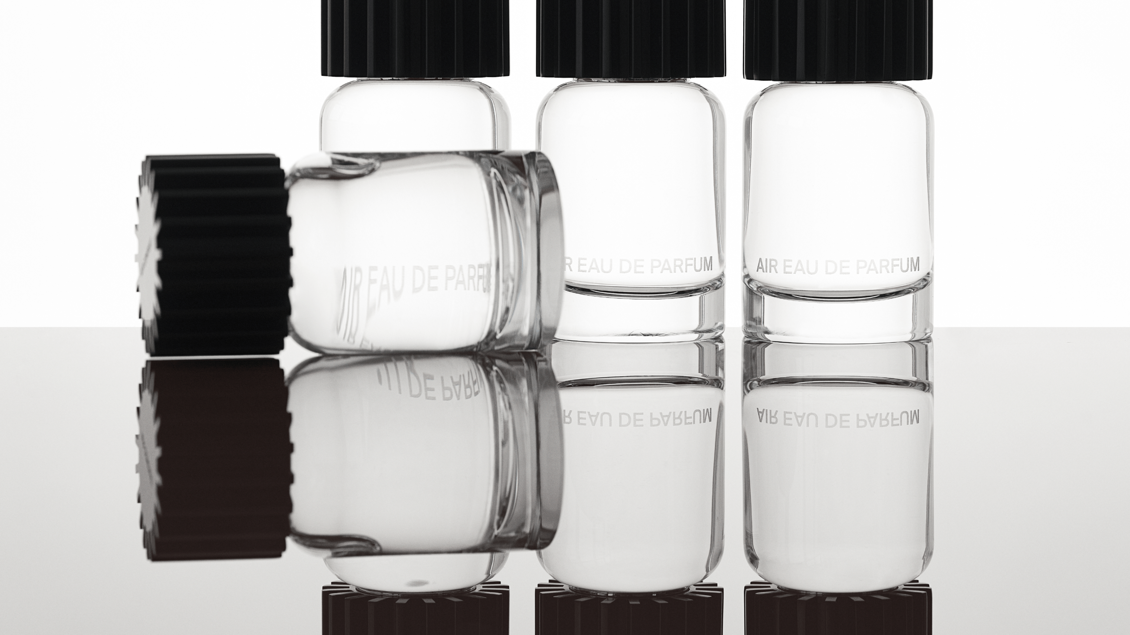 AIRCO (formerly AIR COMPANY)'s fragrance bottles in a row and one laying down in front.