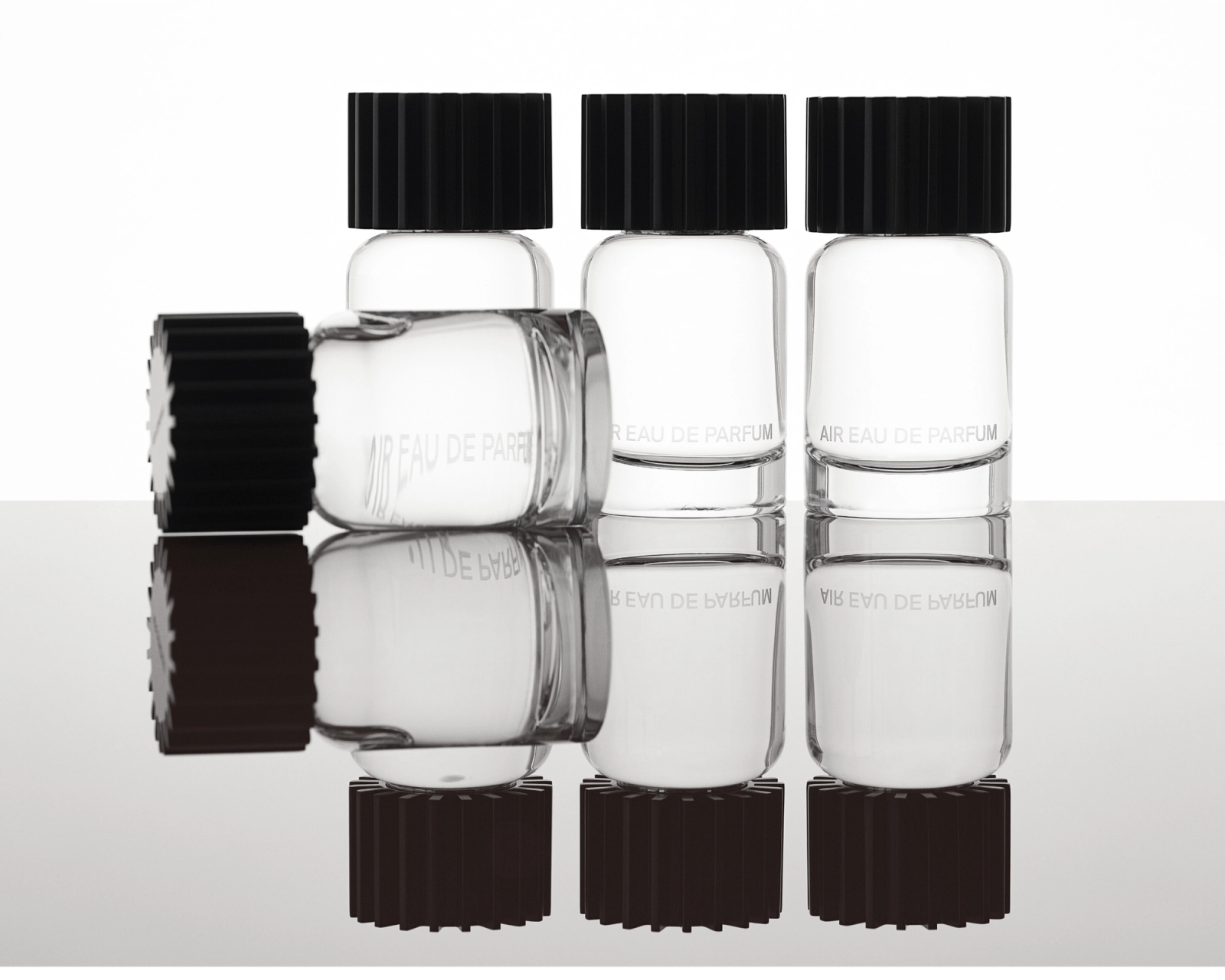 AIRCO (formerly AIR COMPANY)'s fragrance bottles in a row and one laying down in front.