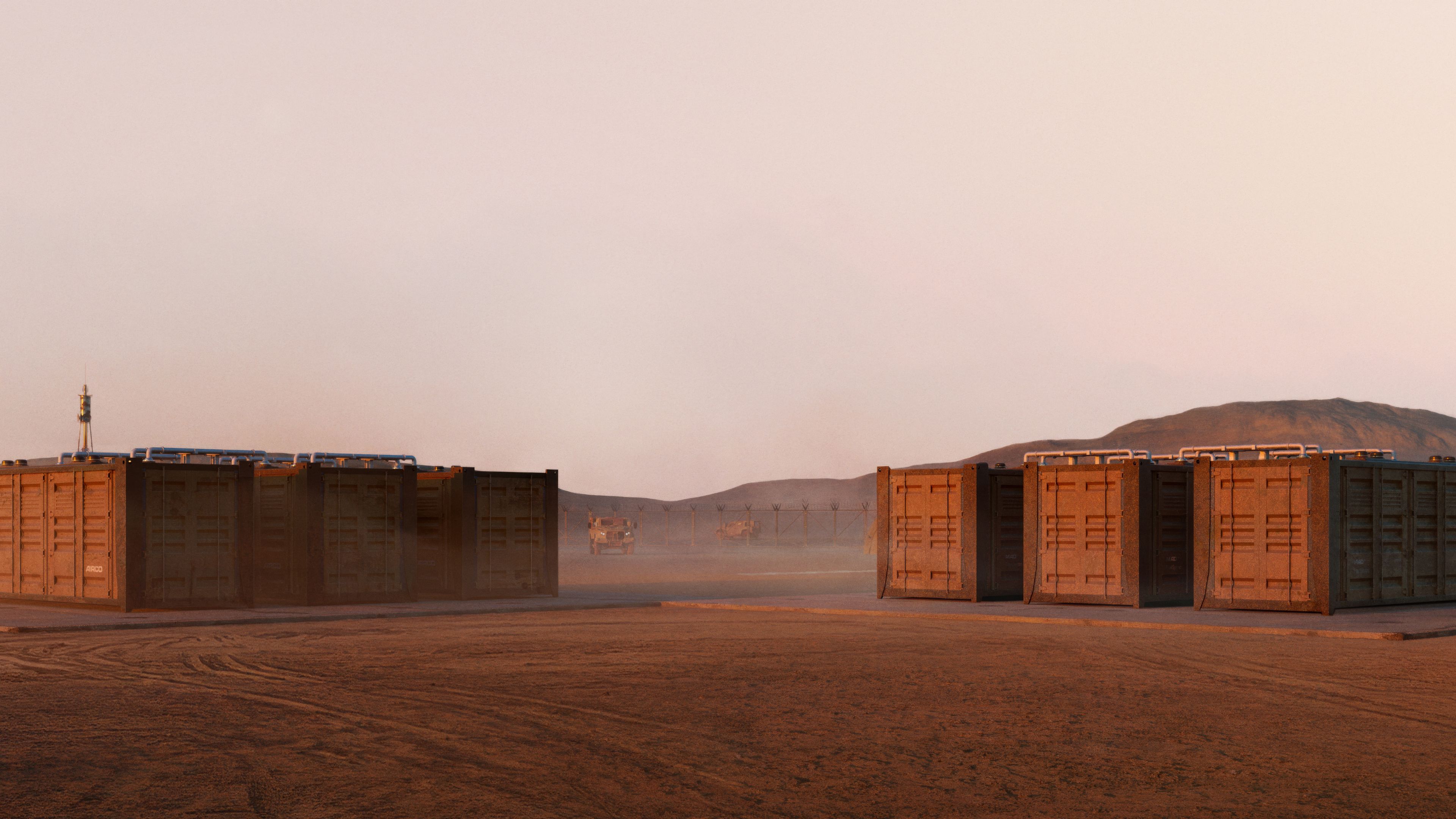 Two structures built from shipping containers, one topped with solar panels, in a vast red desert at sunset.