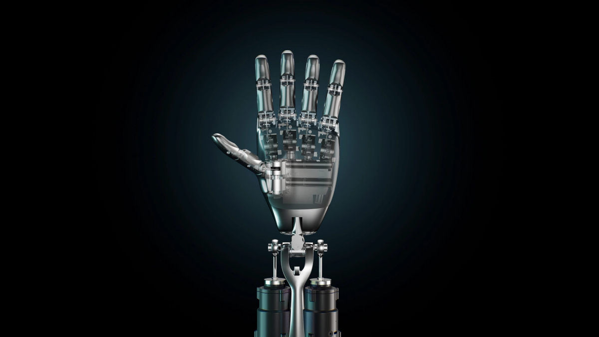 Detailansicht einer Tesla-Optimus-Hand mit fünf Fingern in halb geöffneter Pose, metallisch-glänzende Oberfläche vor dunklem Hintergrund.