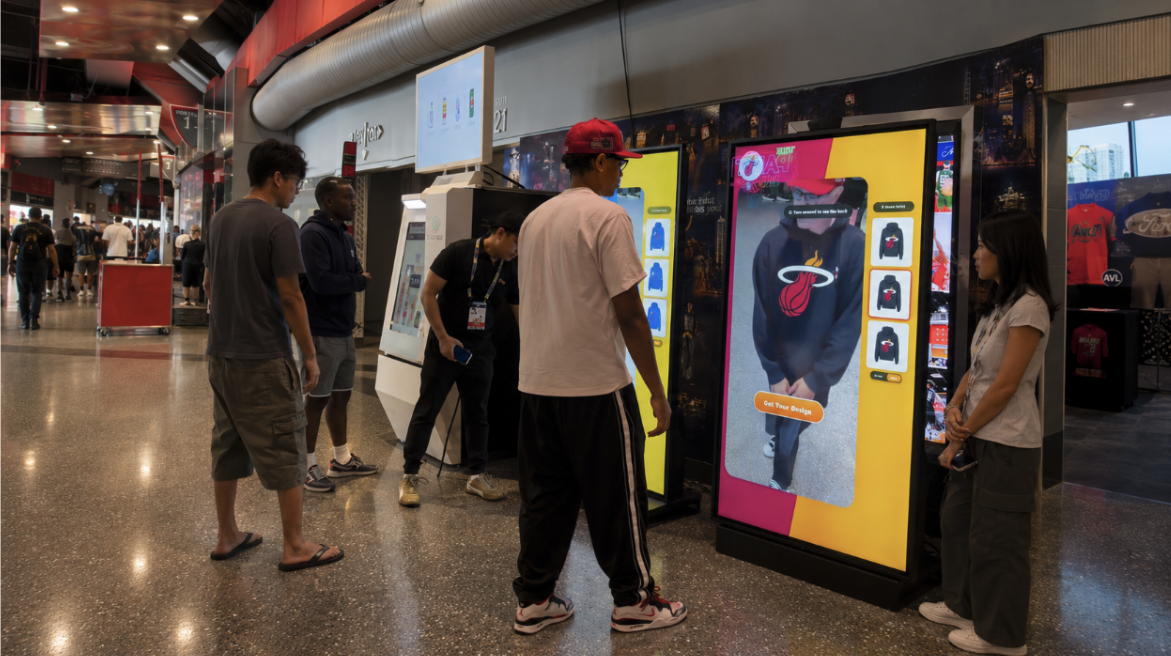Fans trying on personalized merchandise virtually at LiveX gateways on the stadium concourse