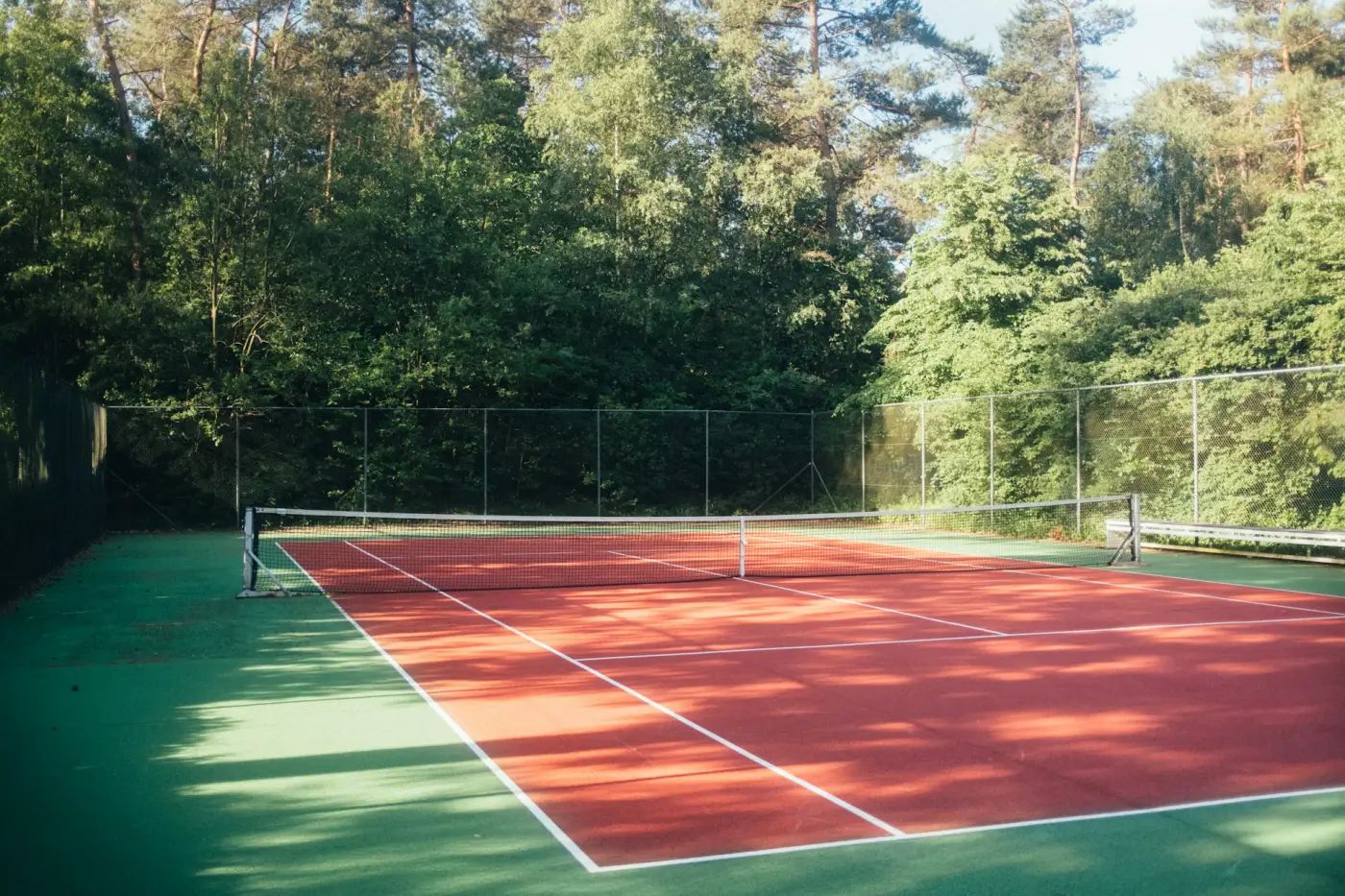 Tennis court between the trees, suitable for conversion to padel