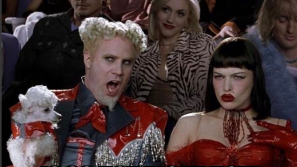 Zoolander ‘so hot right now’ meme. Mugatu (Will Ferrell) sits in a fashion-show audience wearing a shiny red outfit and holding a small white poodle, mouth open in excited mid-shout, with a stern dark-haired woman in red beside him. White impact-font text at the top reads ‘STRATEGY’ and at the bottom ‘IS SO HOT RIGHT NOW.