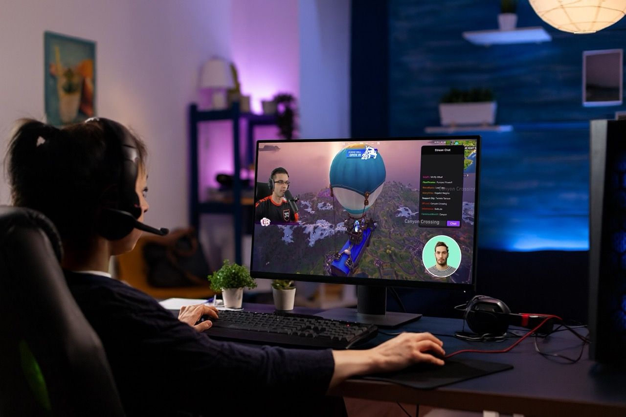 A gamer at a computer monitor playing a video game, with several floating user interface elements for dialogue and model control visible on the screen.