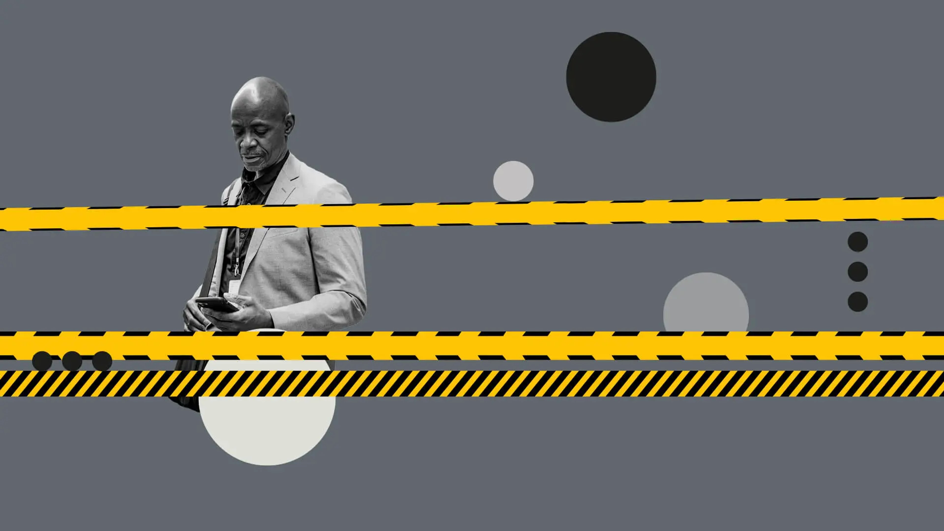 Man looking down at his phone, black and white graphics with yellow tape across the centre. 
