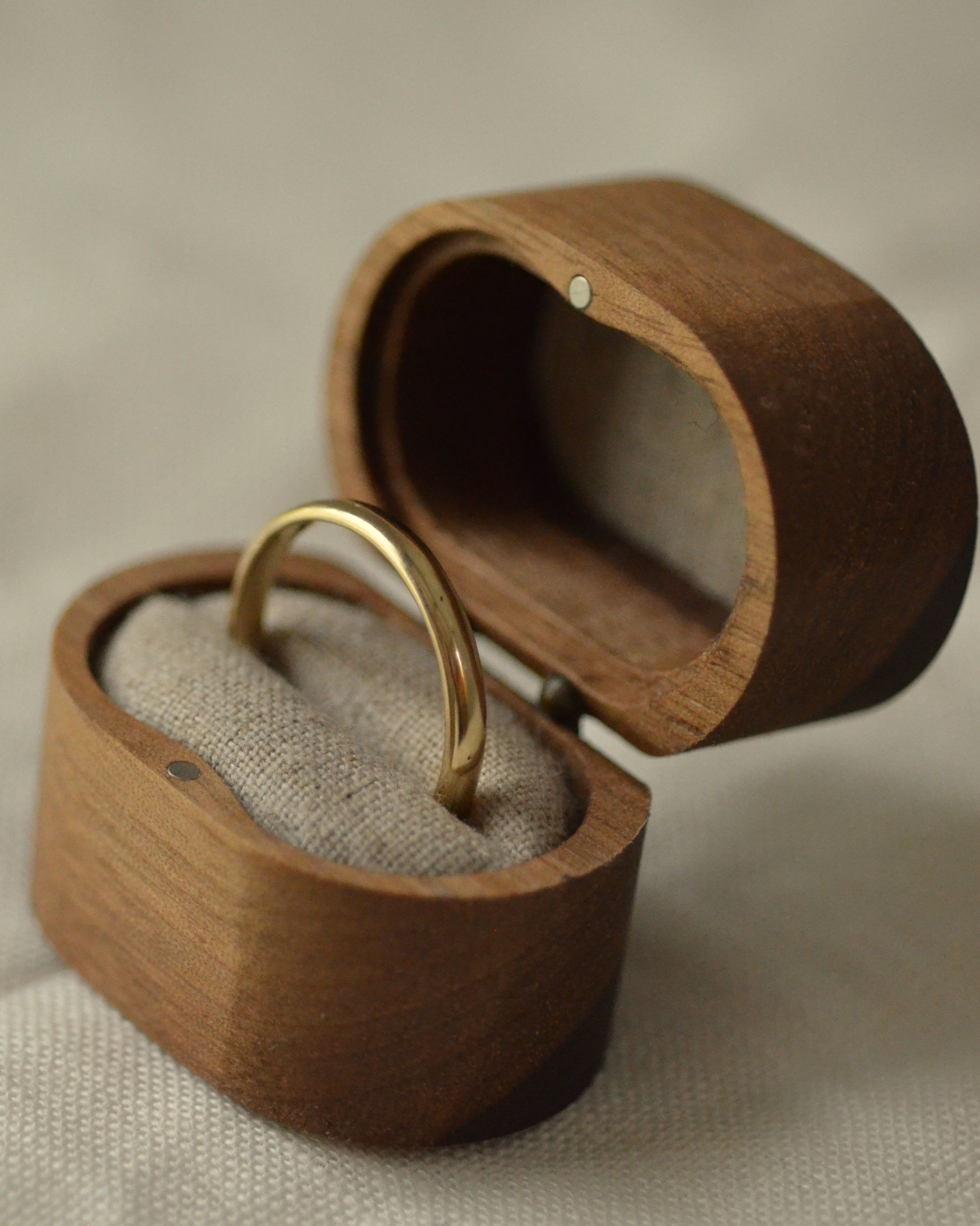 Smooth gold polished ring in wooden presentation box