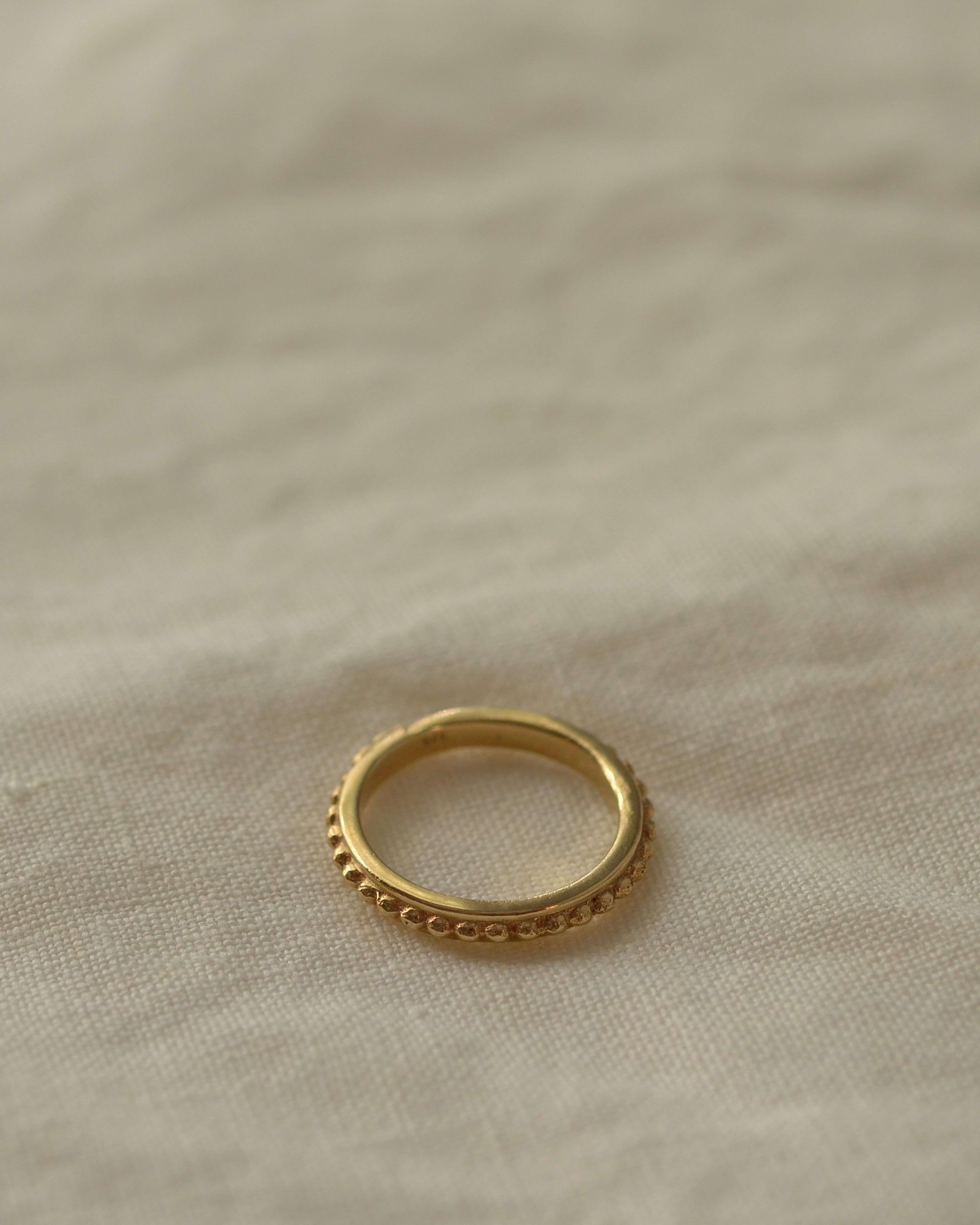 Gold grain stacking ring on cream linen new zealand handmade