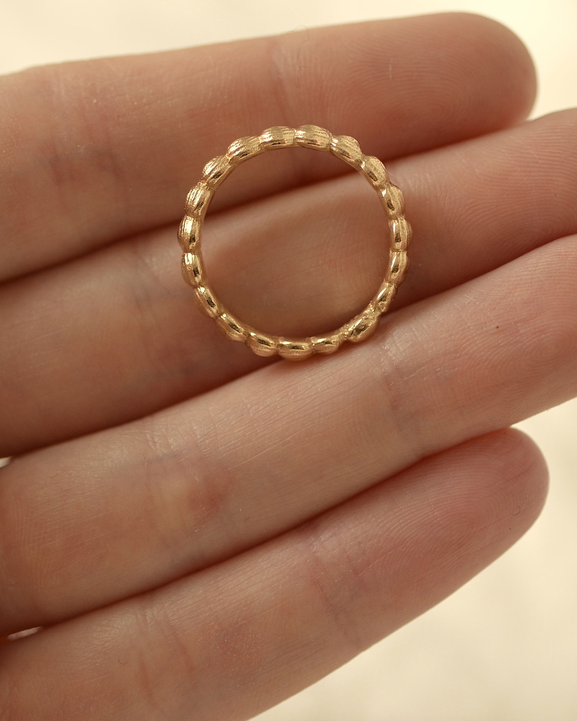 Gold layer ring held in hand