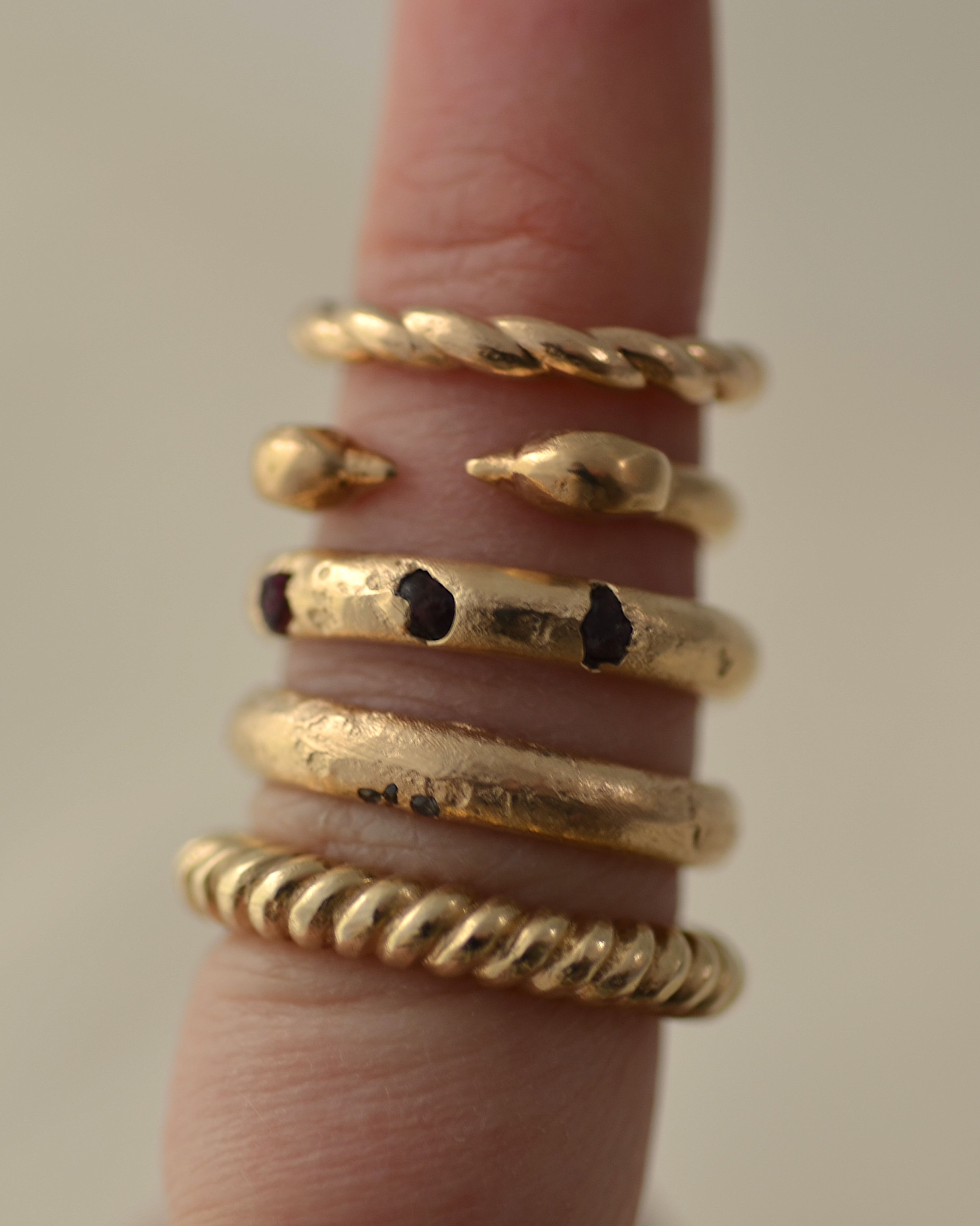 Ridge ring stacked on finger with other rings