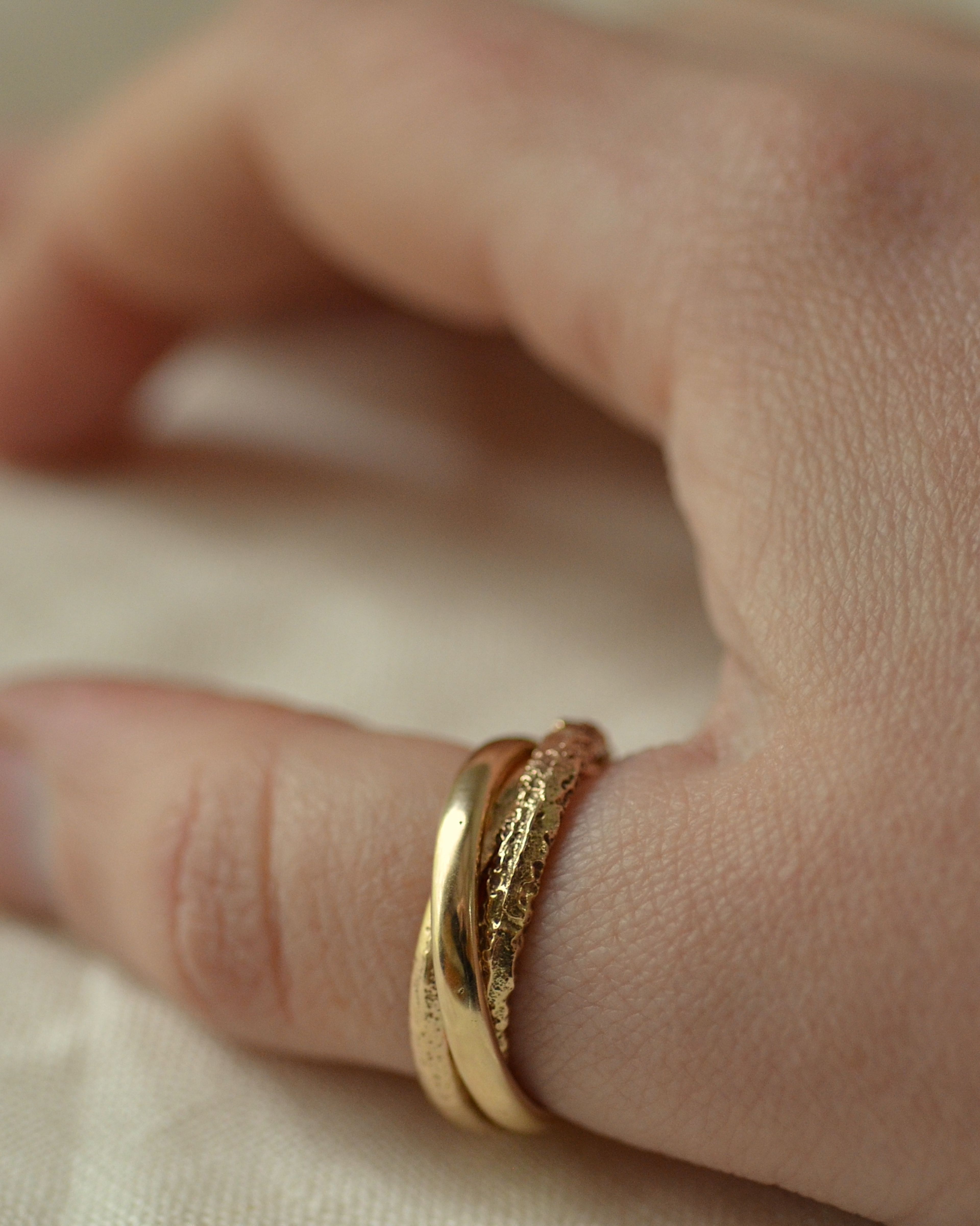 Erosion gold triple ring worn on thumb