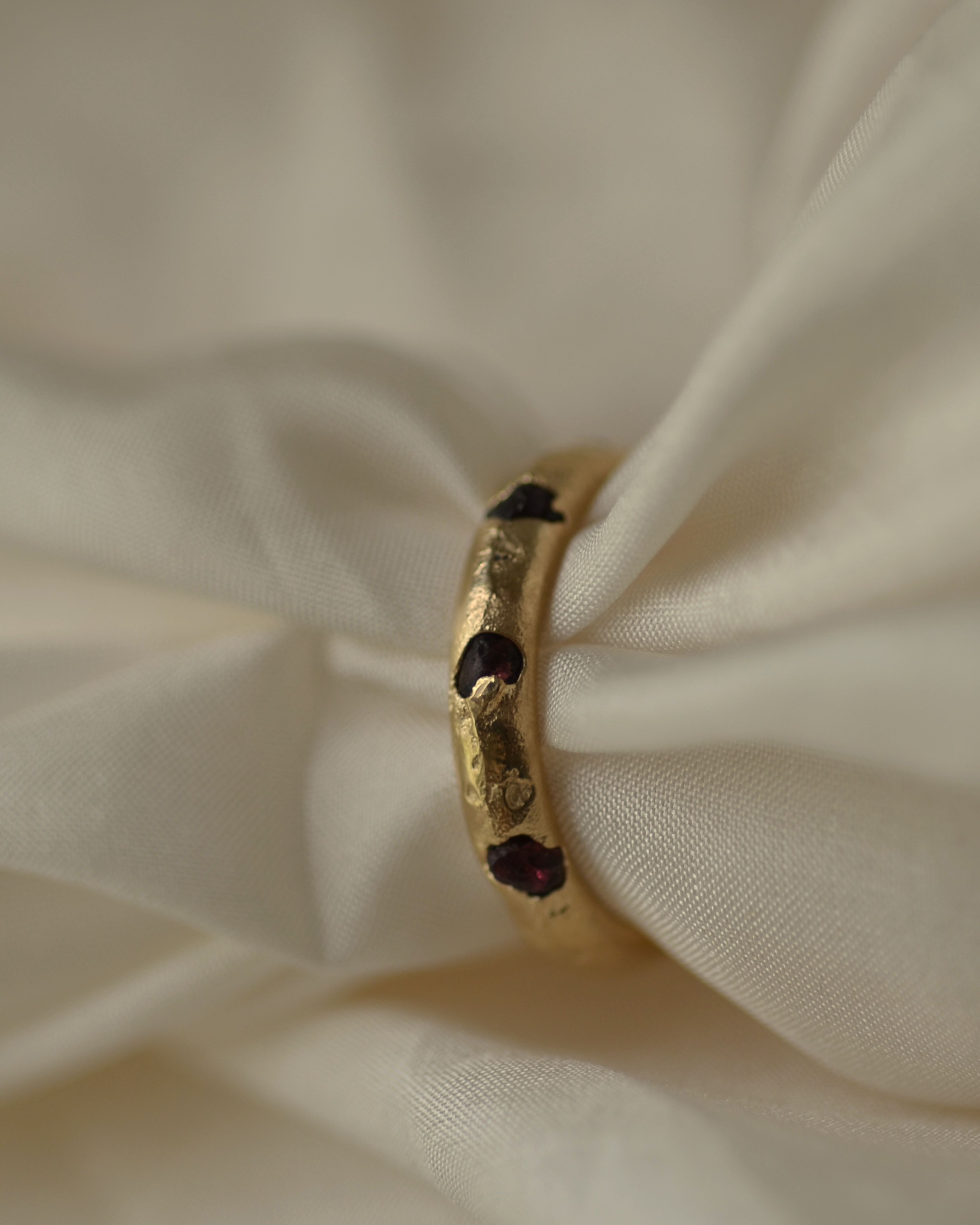 Rough garnets cast in place ring using sustainable alluvial gold from New Zealand West coast