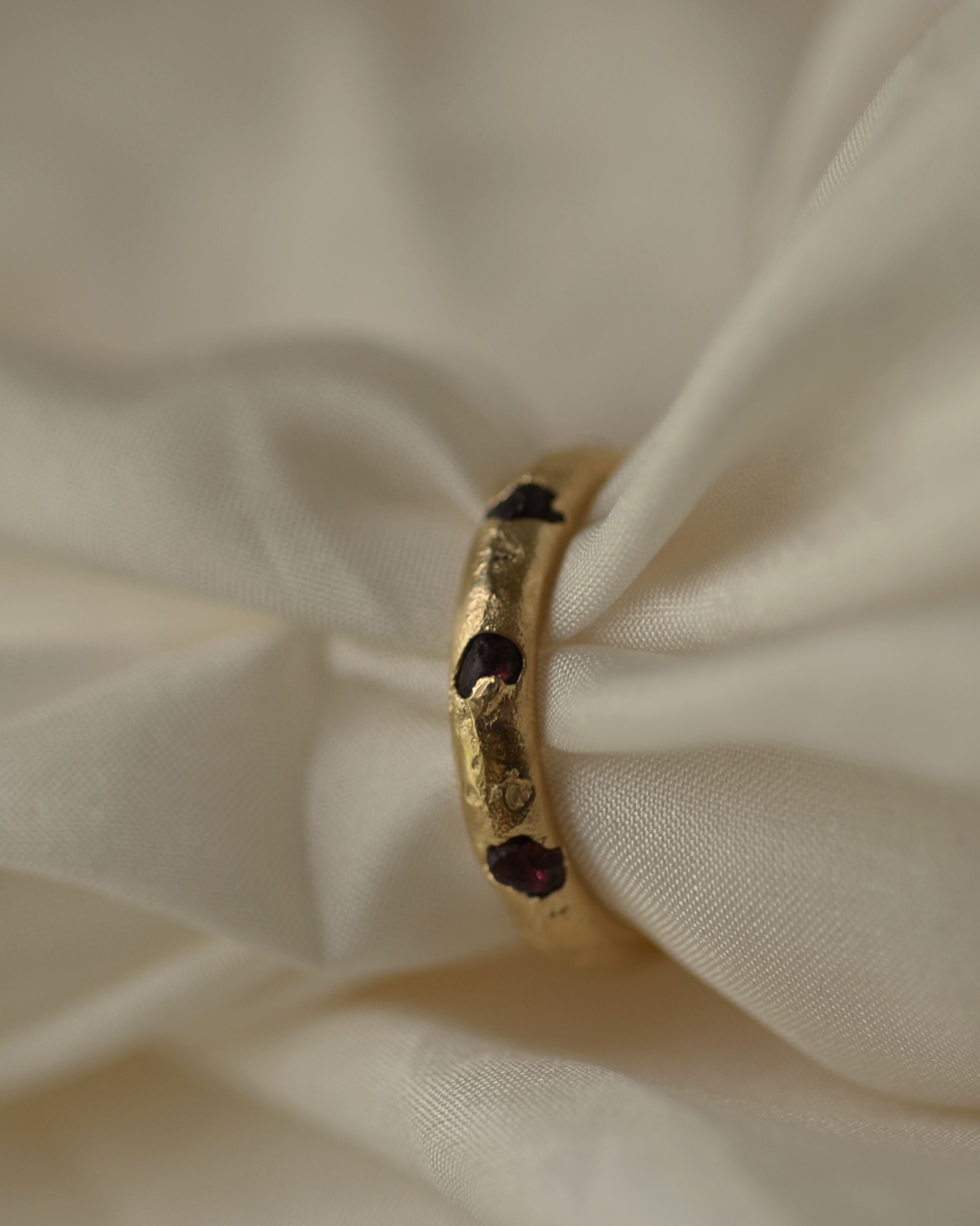 Rough garnets cast in place ring using sustainable alluvial gold from New Zealand West coast