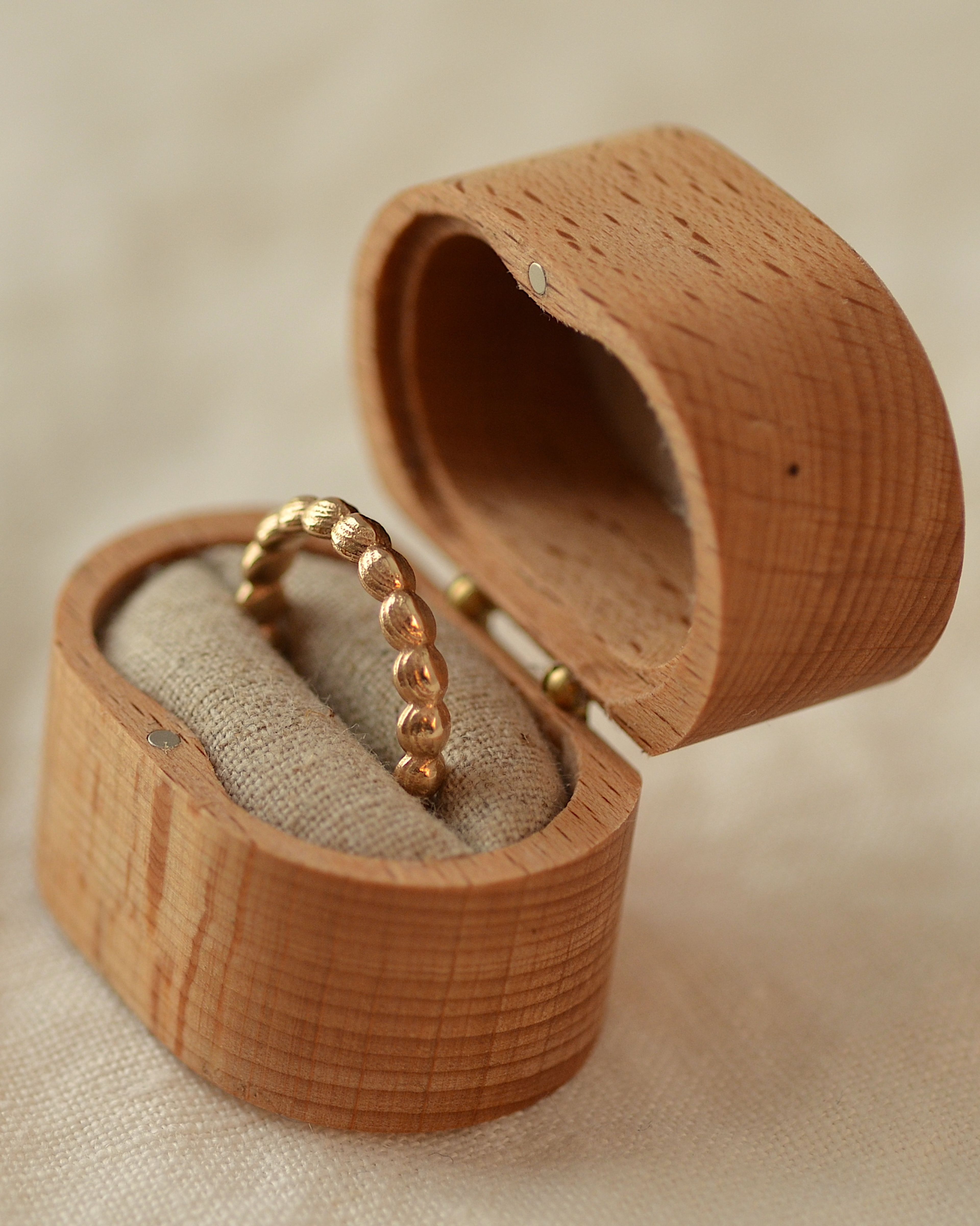 Gold layer ring in wooden presentation box