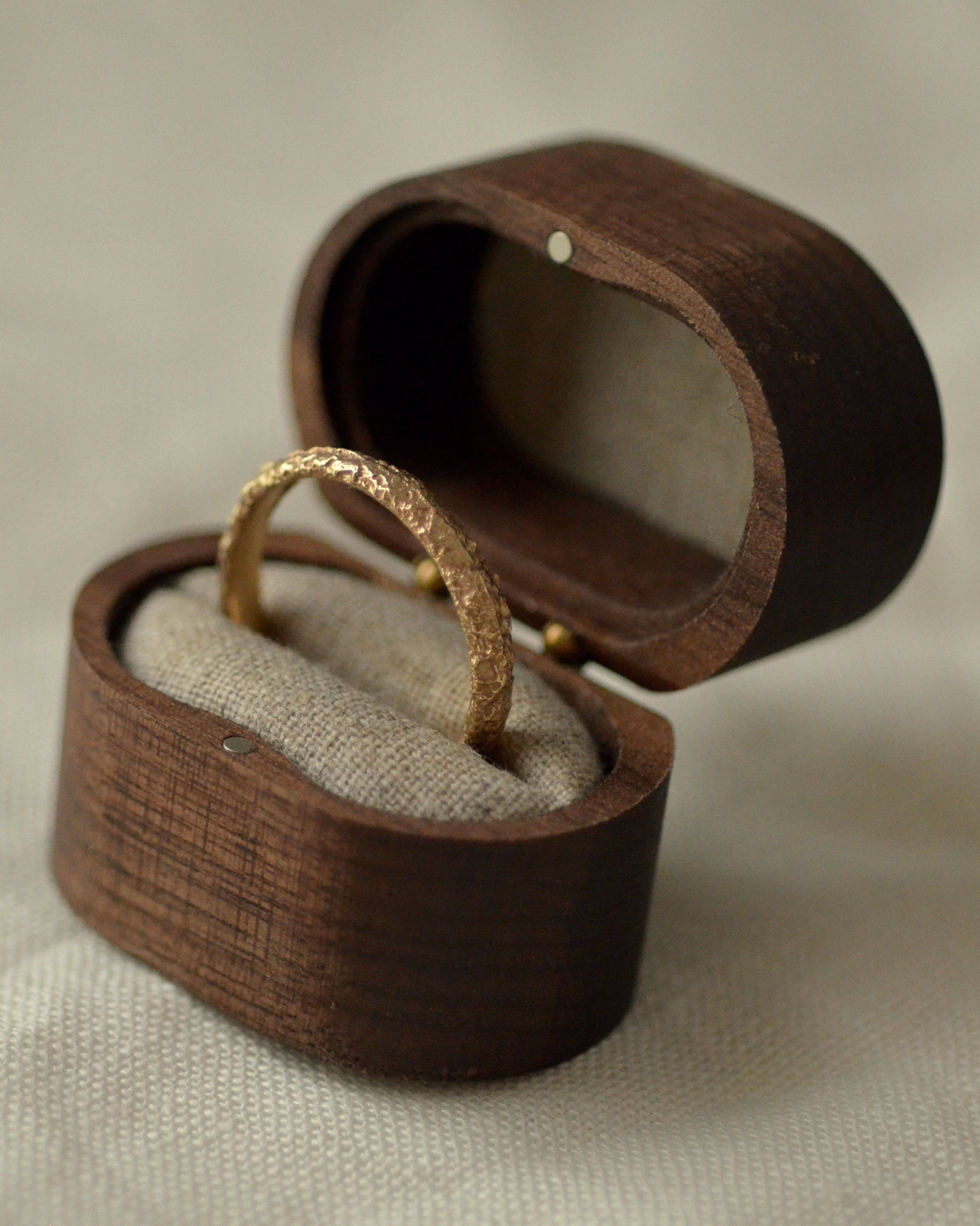Textured salt gold ring in wooden presentation box