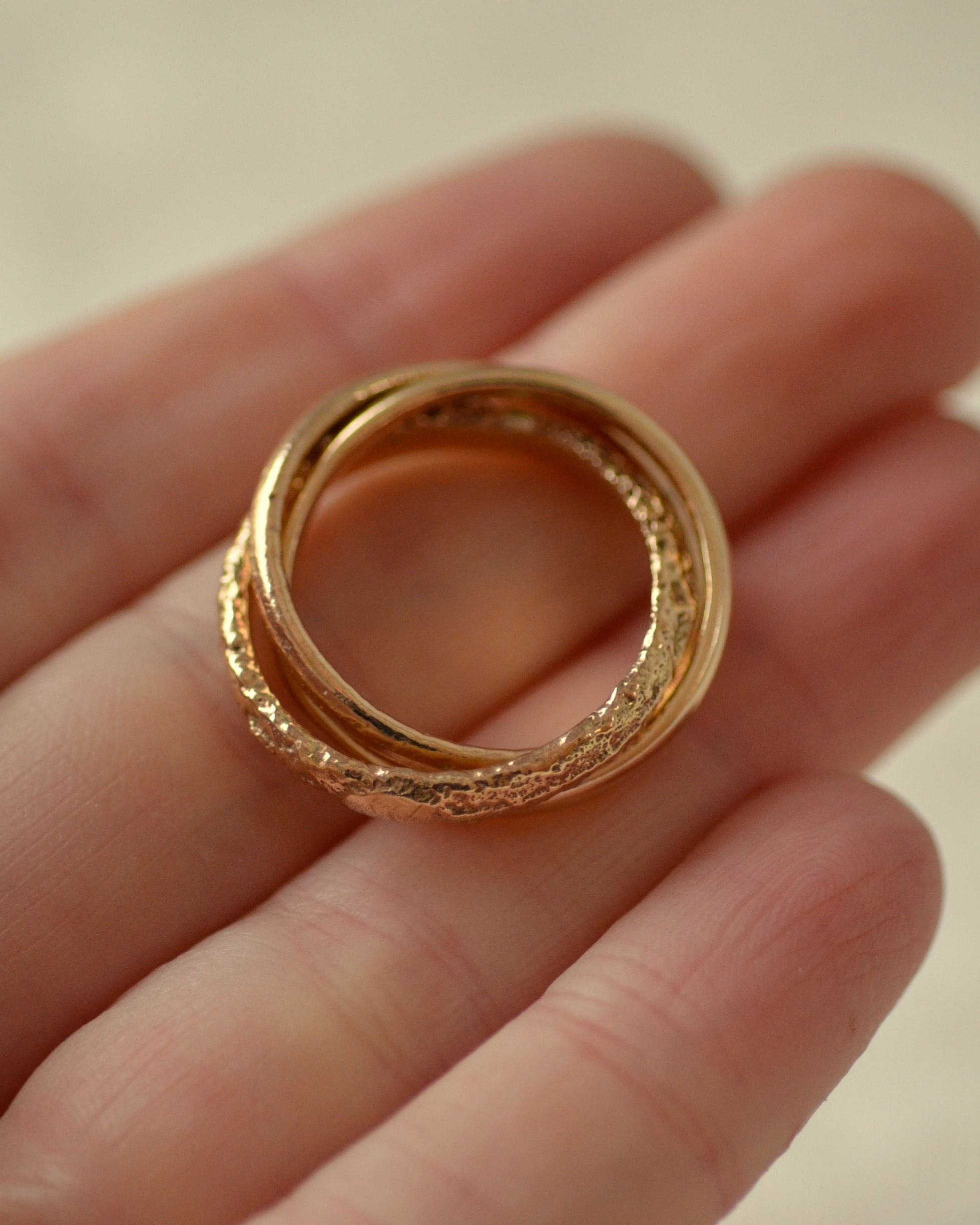 Erosion gold ring held in hand