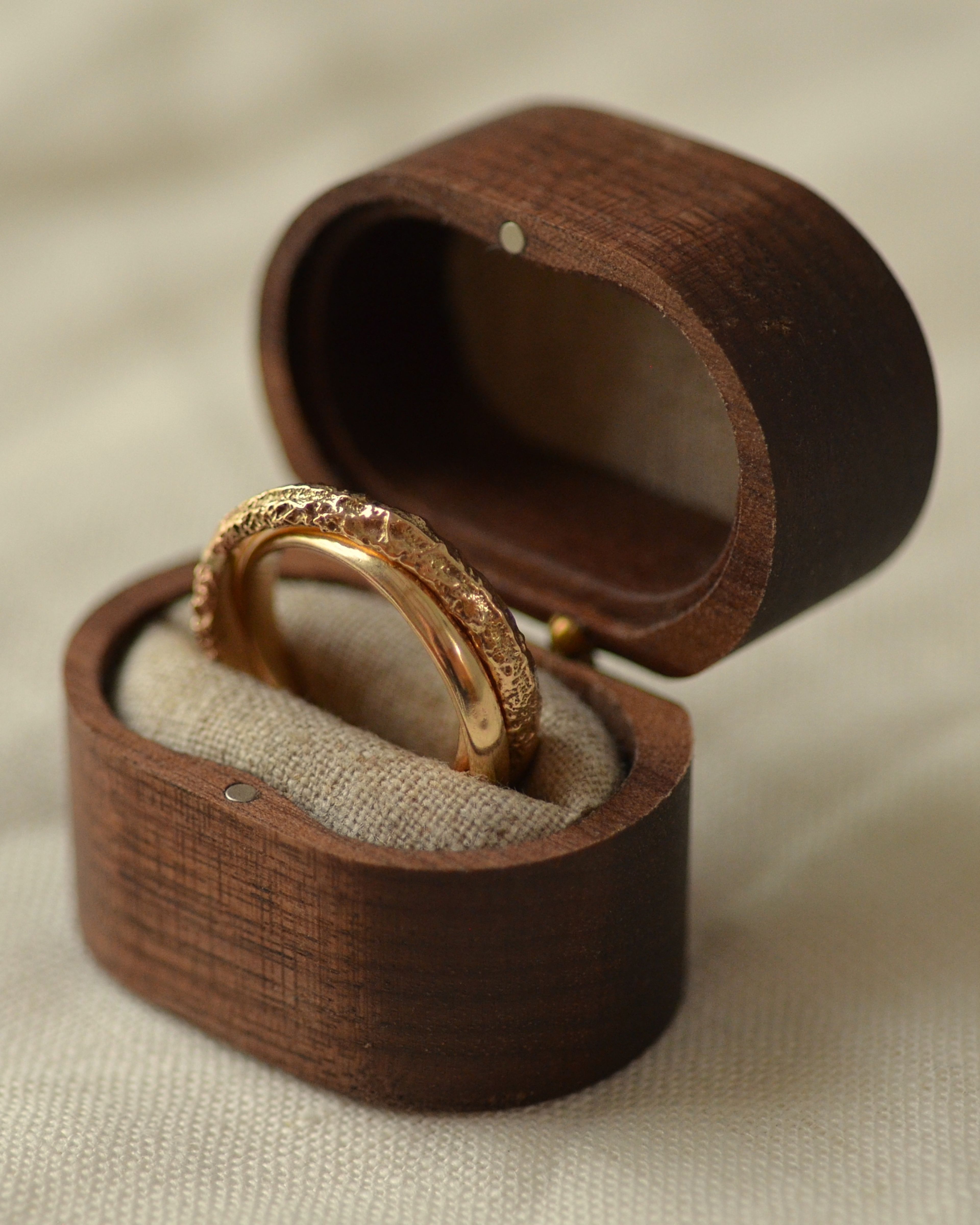 Erosion gold ring in wooden presentation box