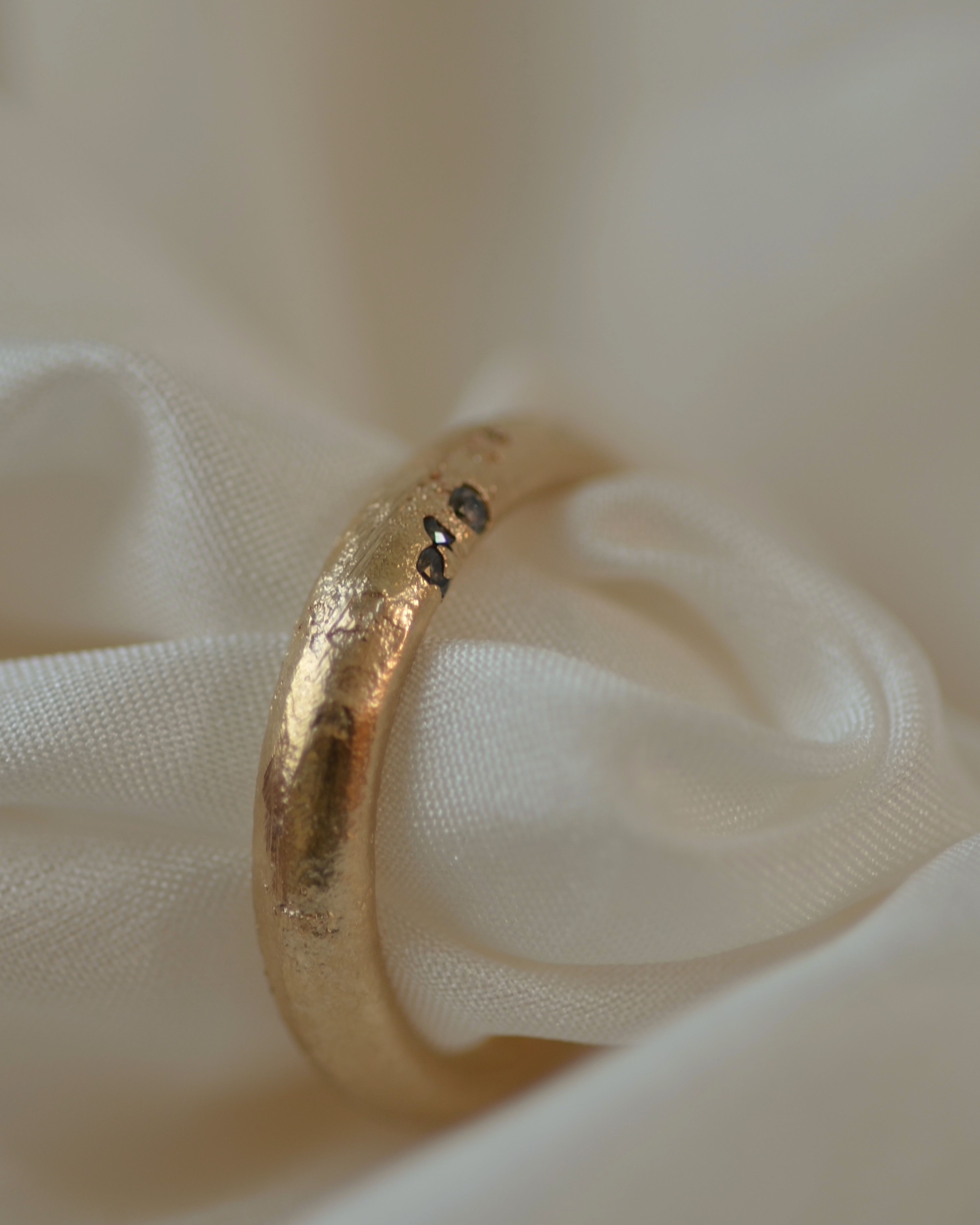 Cast Ring with three diamonds cast in place on cream silk