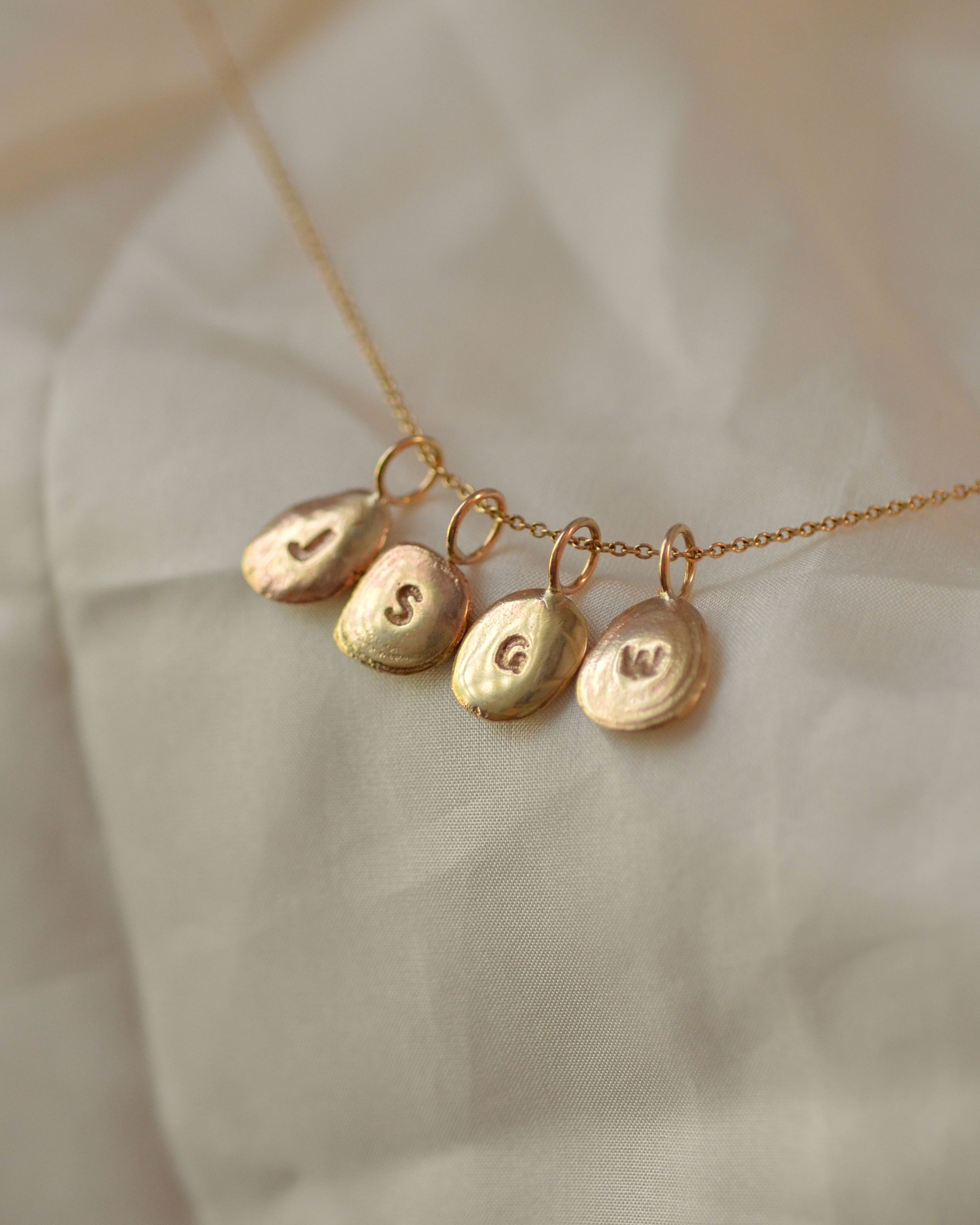 Gold pebble pendants together on a chain