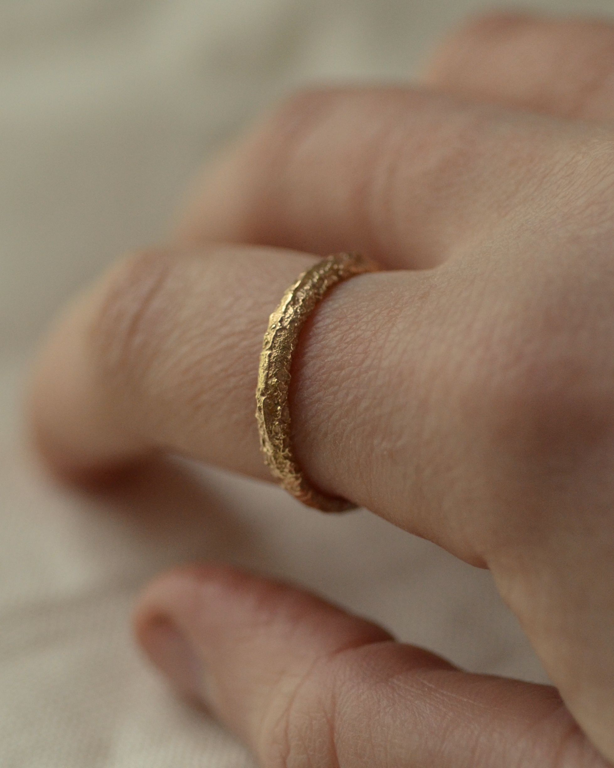 Textured salt gold band worn on finger