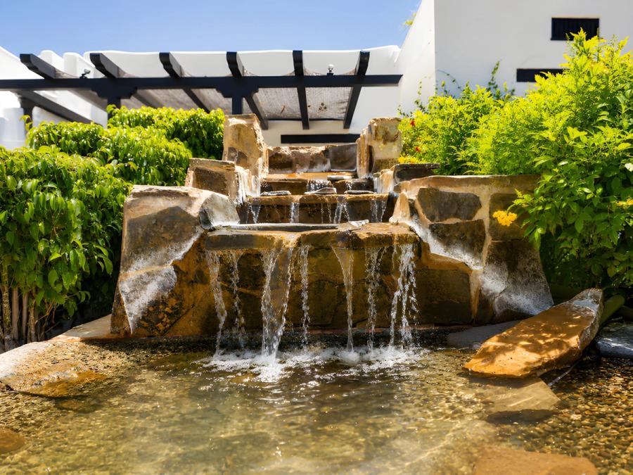 Garden waterfall at Gloria Palm Springs