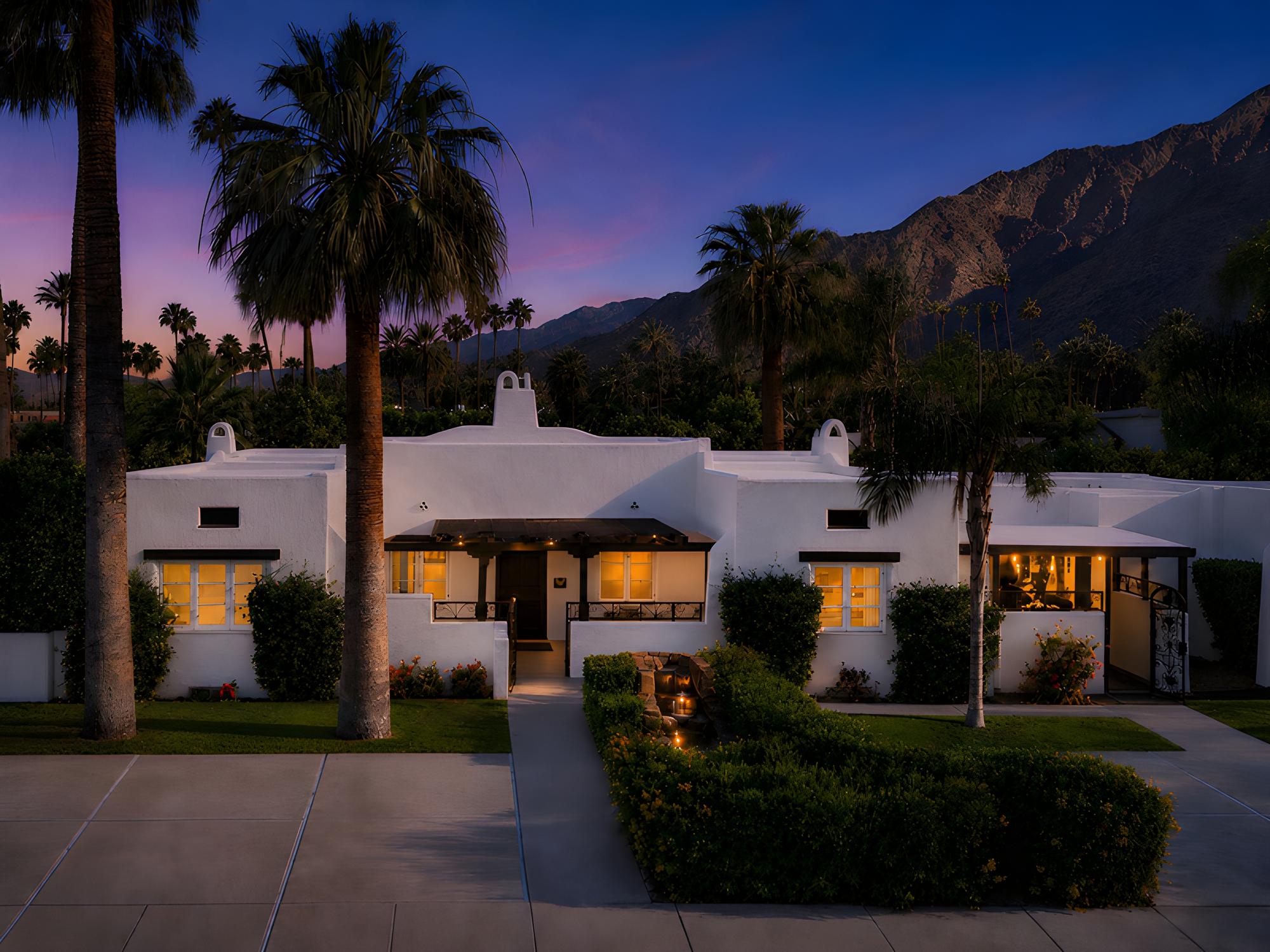 Gloria Palm Springs at dusk beneath the San Jacinto mountains, a boutique hotel in downtown Palm Springs