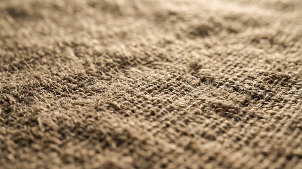 Macro detail of woven linen in raking light