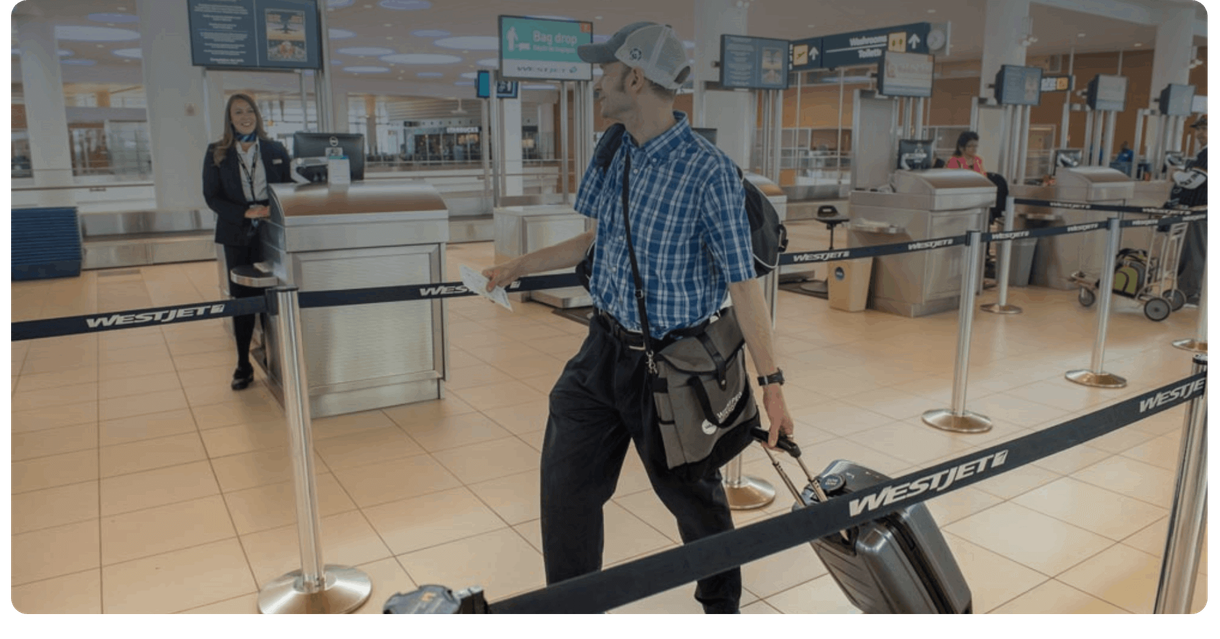 A traveller with a suitcase walks through the check-in area