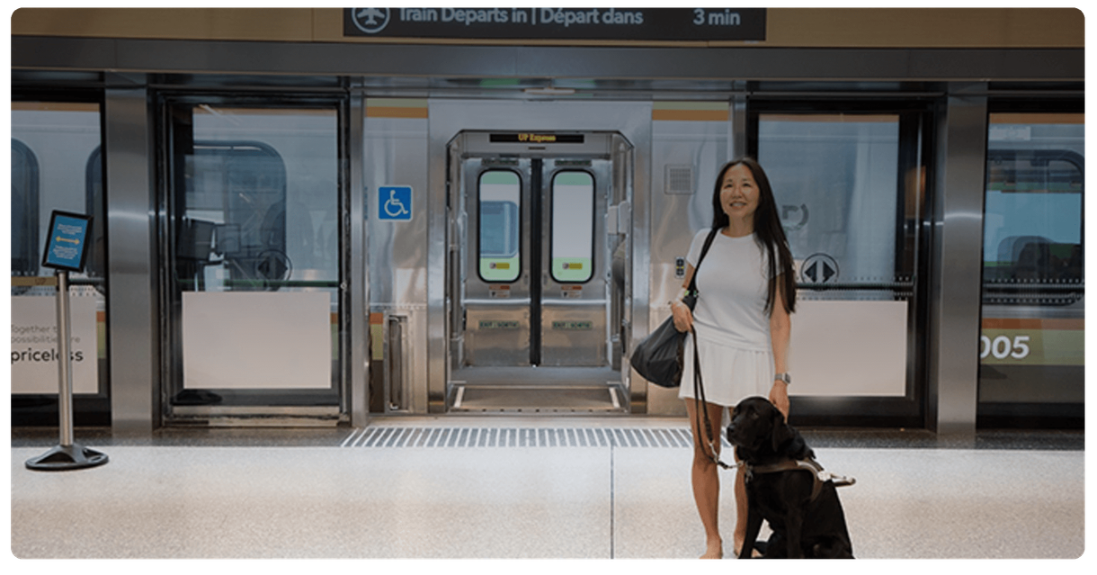 A rider with a guide dog on an UP Express platform